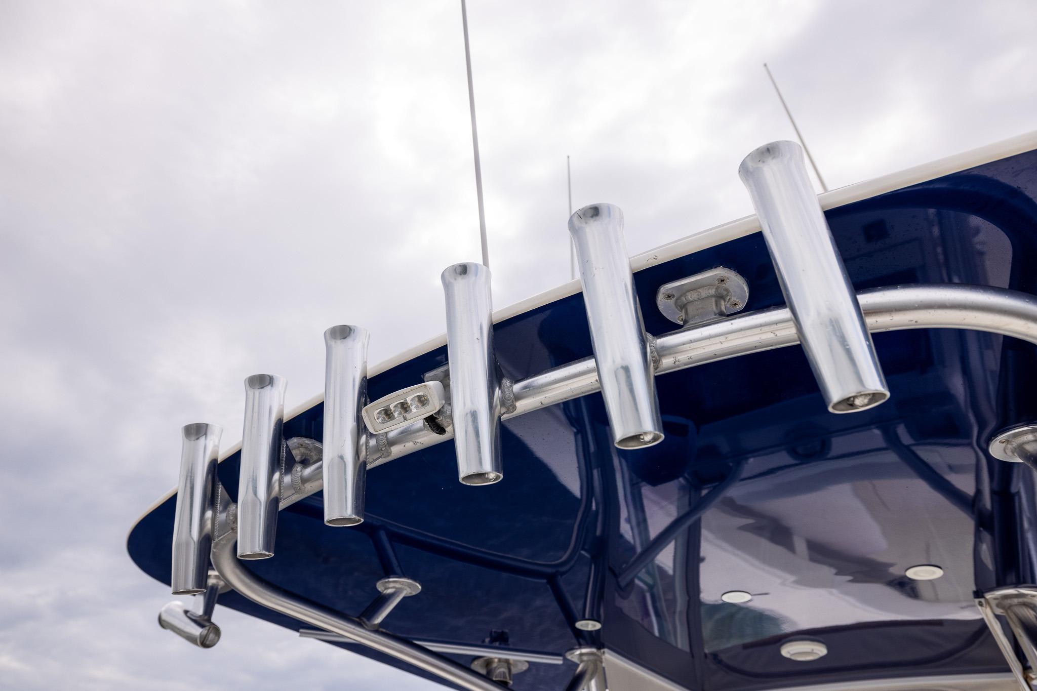 Rod holders on a 2019 SeaVee 322Z boat against a cloudy sky.