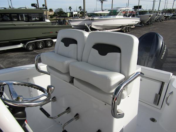 2025 Wellcraft 243 Fisherman boat interior with dual white seats and steering wheel.