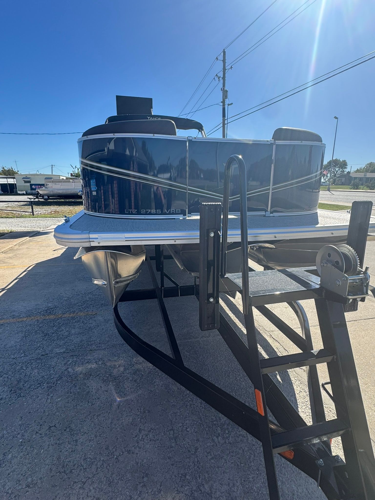 2025 Tahoe 2585 LTZ VRB boat on trailer under sunny sky.