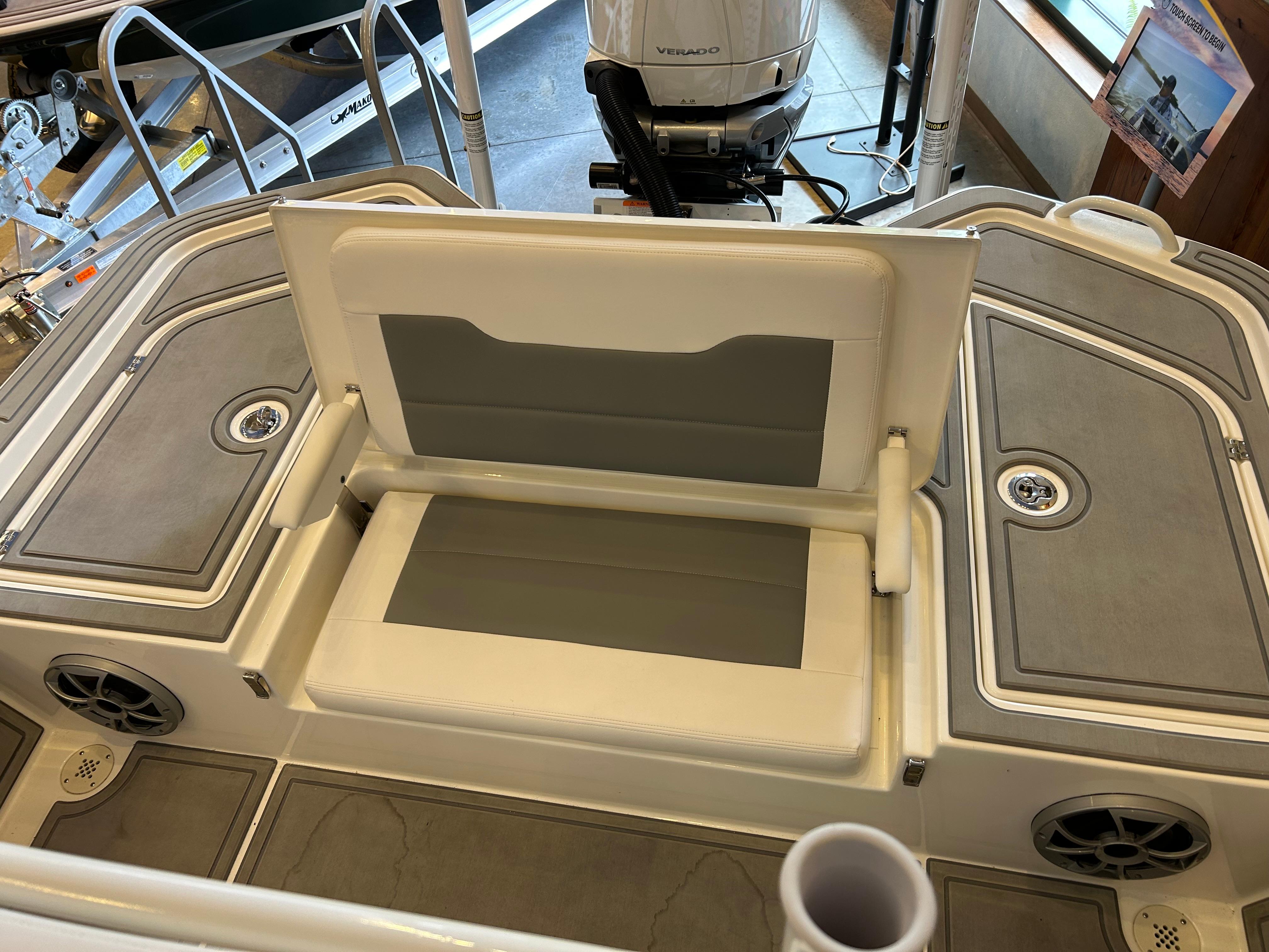 2025 Mako 24 APEX boat interior with foldable seating and storage compartments.