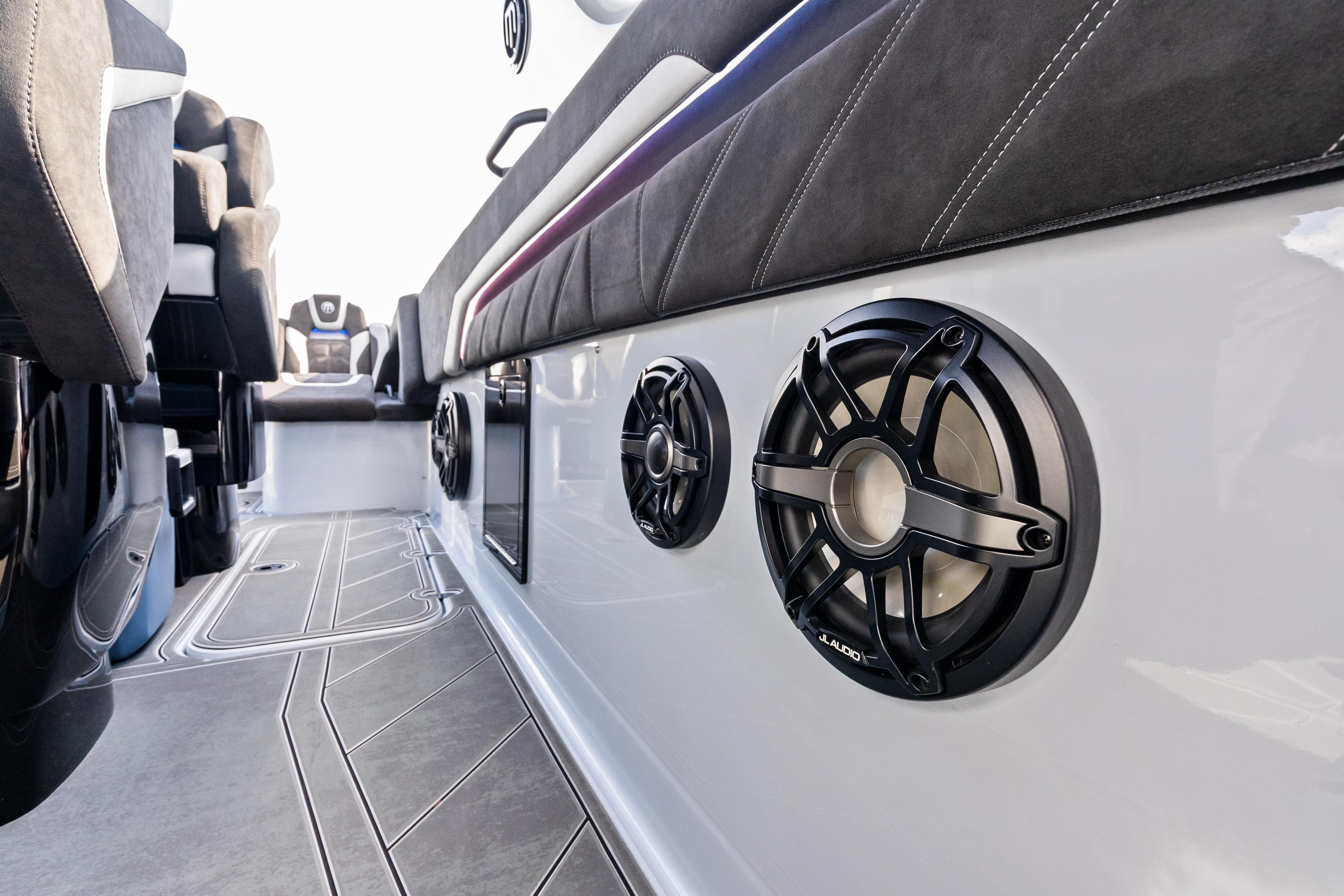 Interior of 2027 Mystic Powerboats M4200 featuring sleek seating and premium audio speakers.