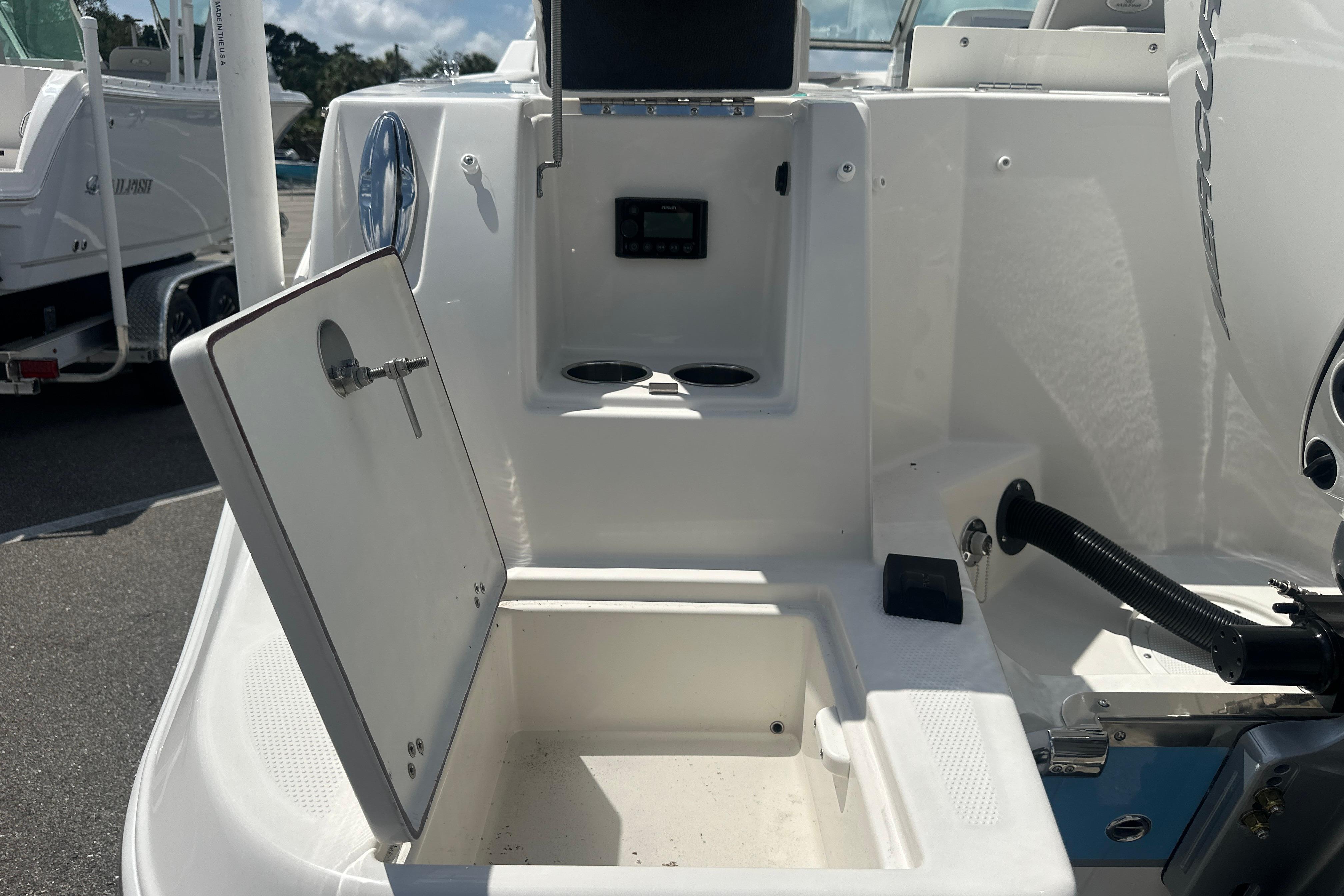 Open storage compartment on a 2026 Sailfish 226 DC boat, showcasing interior features.