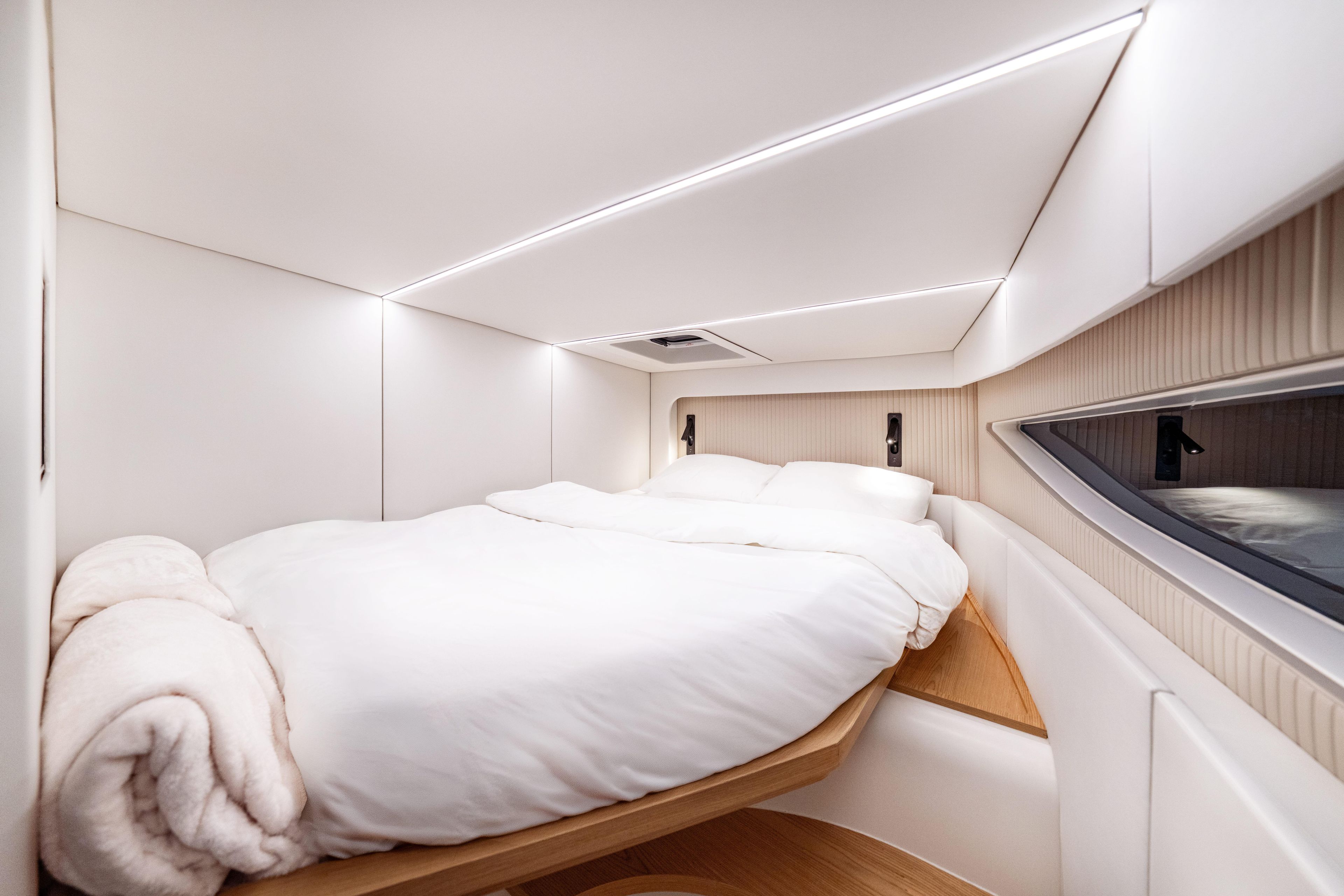 Luxurious bedroom interior of 2025 Sunreef 55 ULTIMA yacht with modern design.