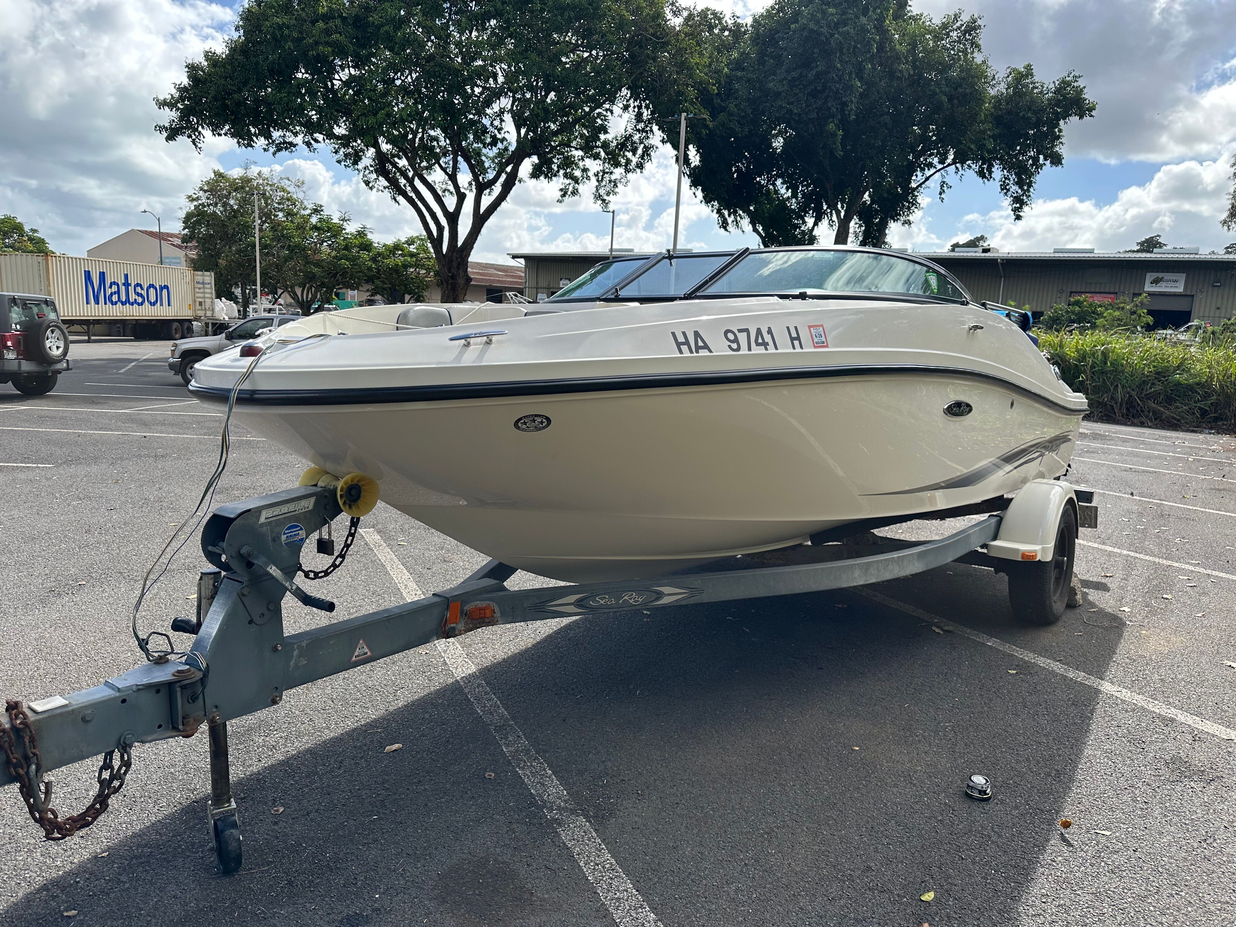 2011 Sea Ray 185 Sport boat on trailer parked outdoors.