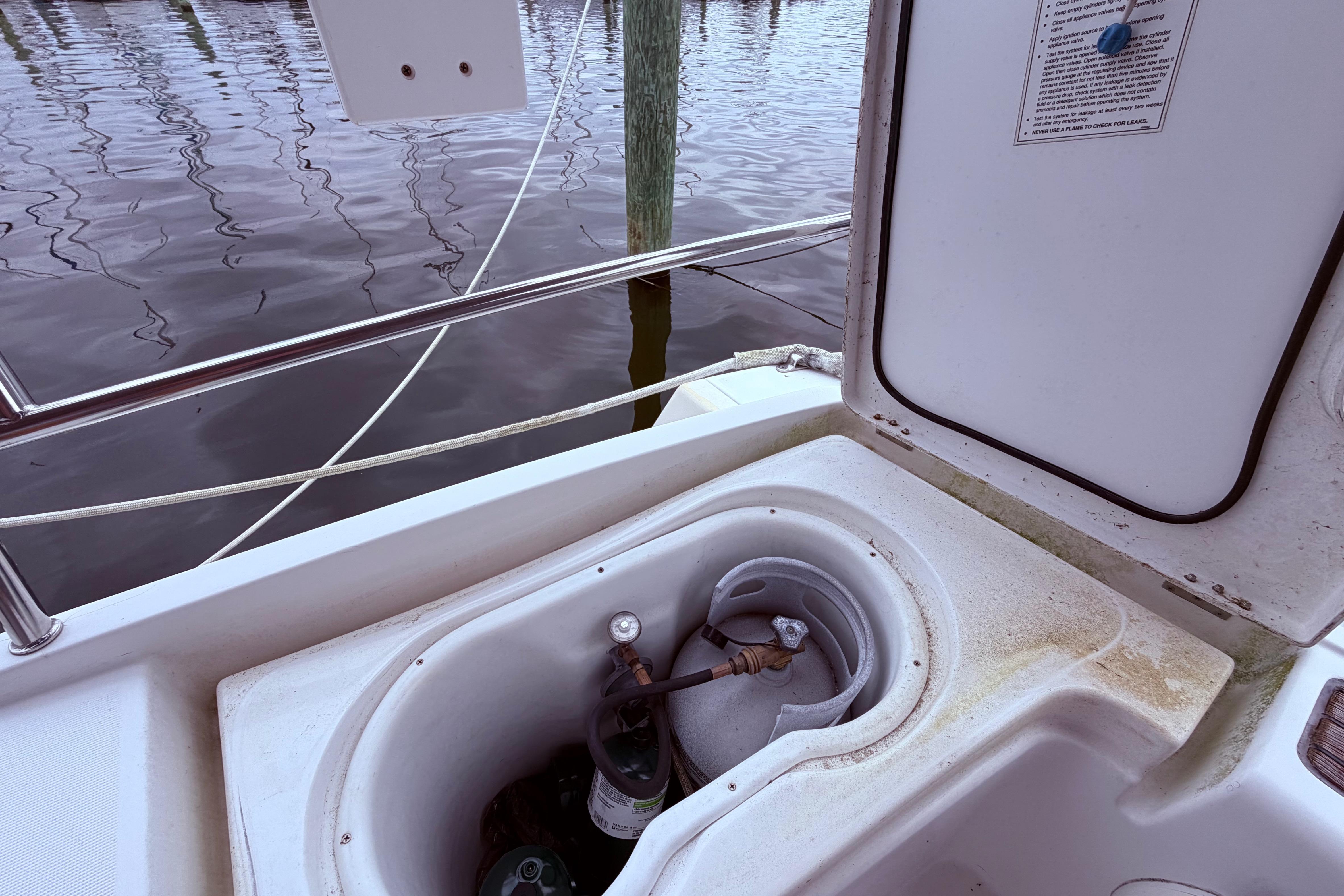 Propane locker on port side behind helm
