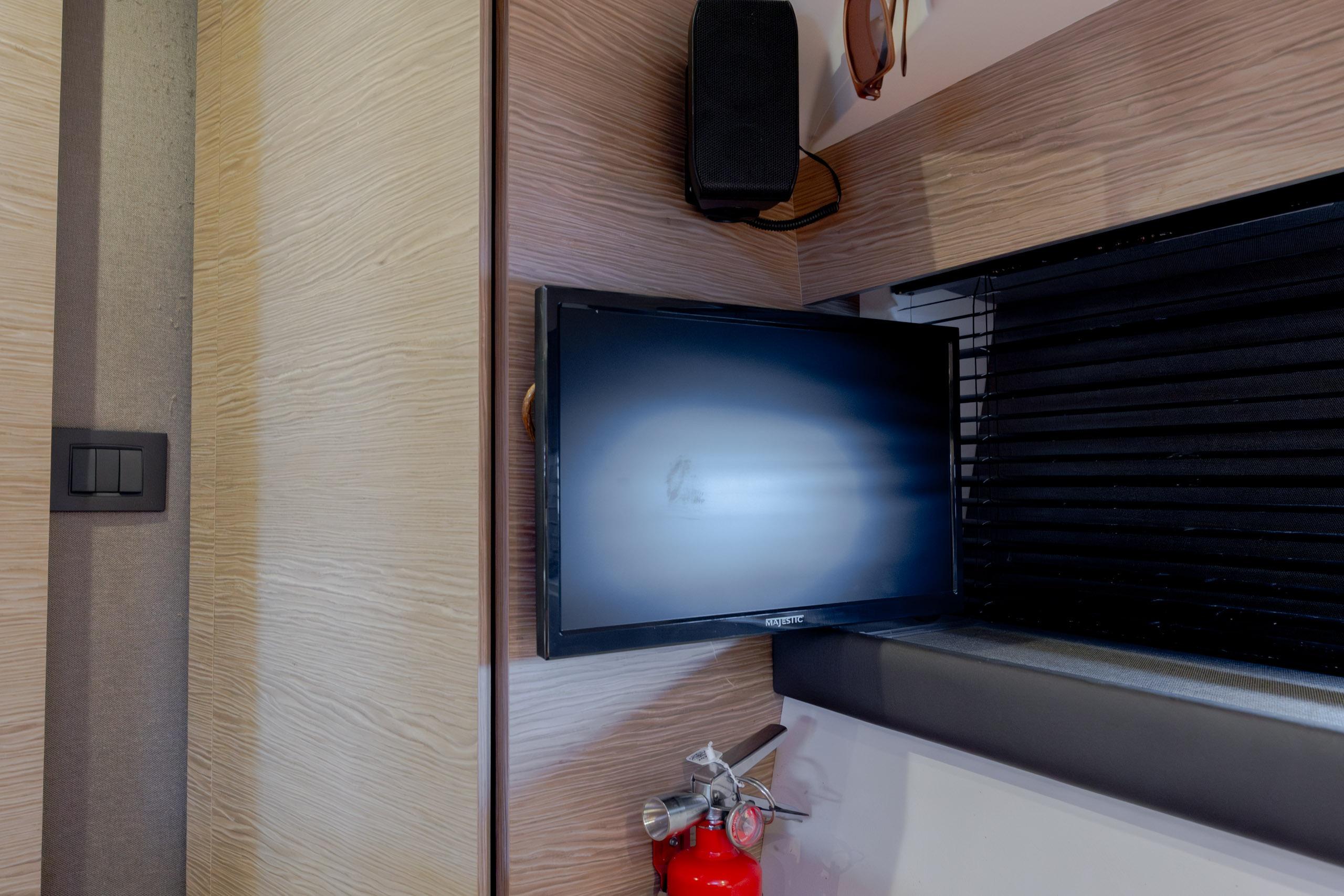 Interior of 2019 Azimut Verve 40 yacht with TV, speaker, and fire extinguisher.