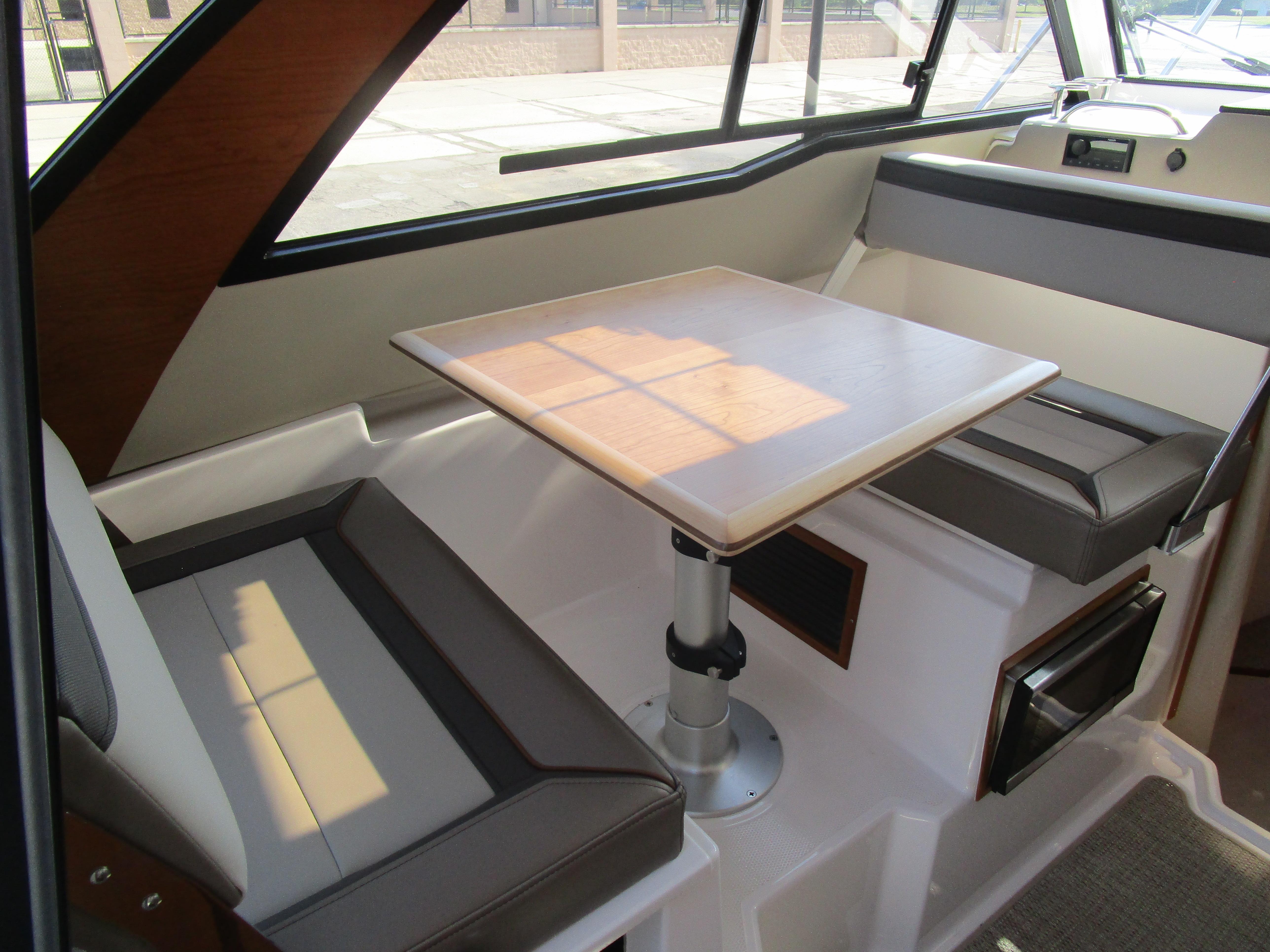 2025 Cutwater C-248 Coupe interior with dining area and modern seating.