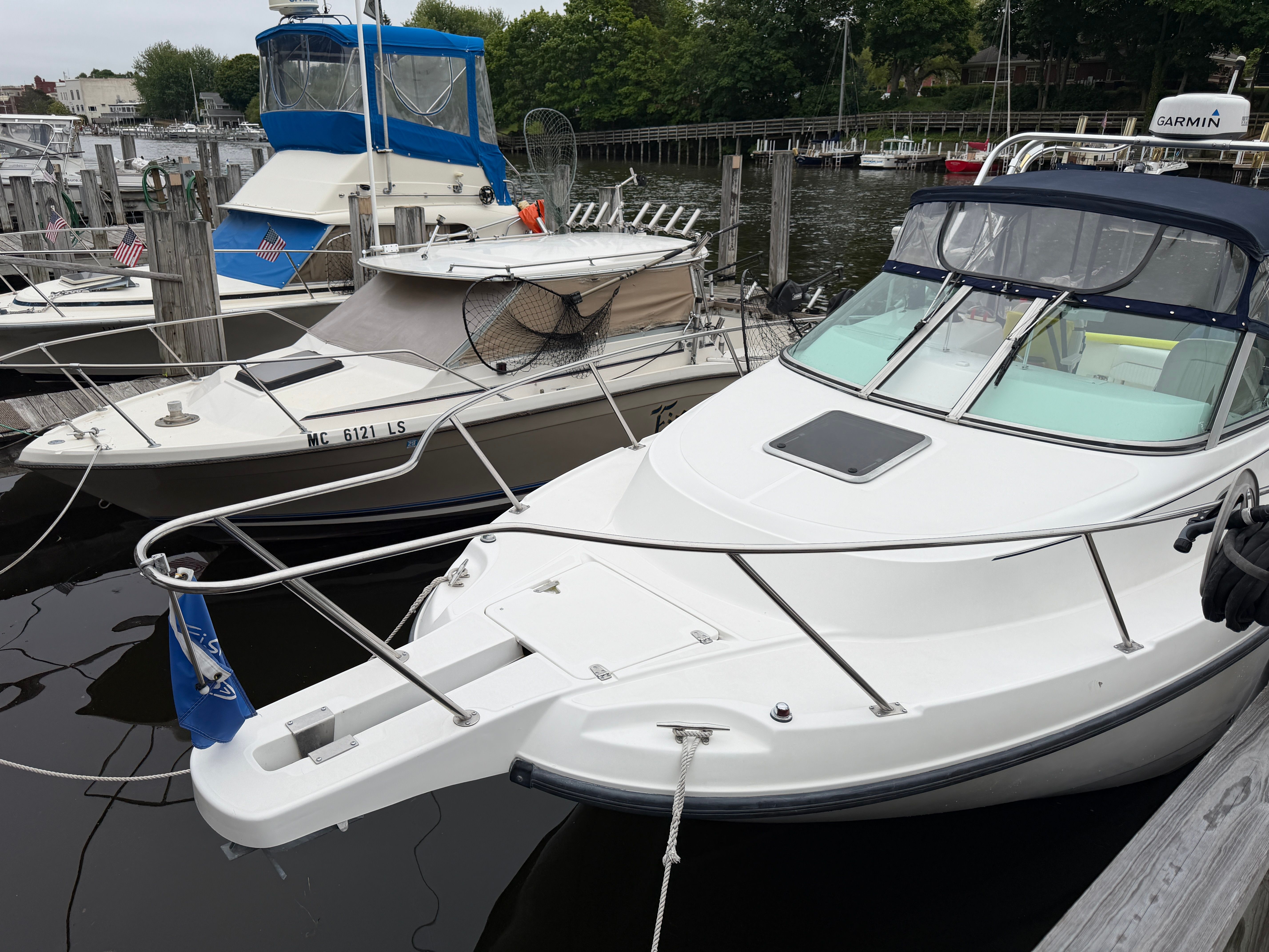 Two boats are docked. One is a 2001 Boston Whaler 26 Conquest.