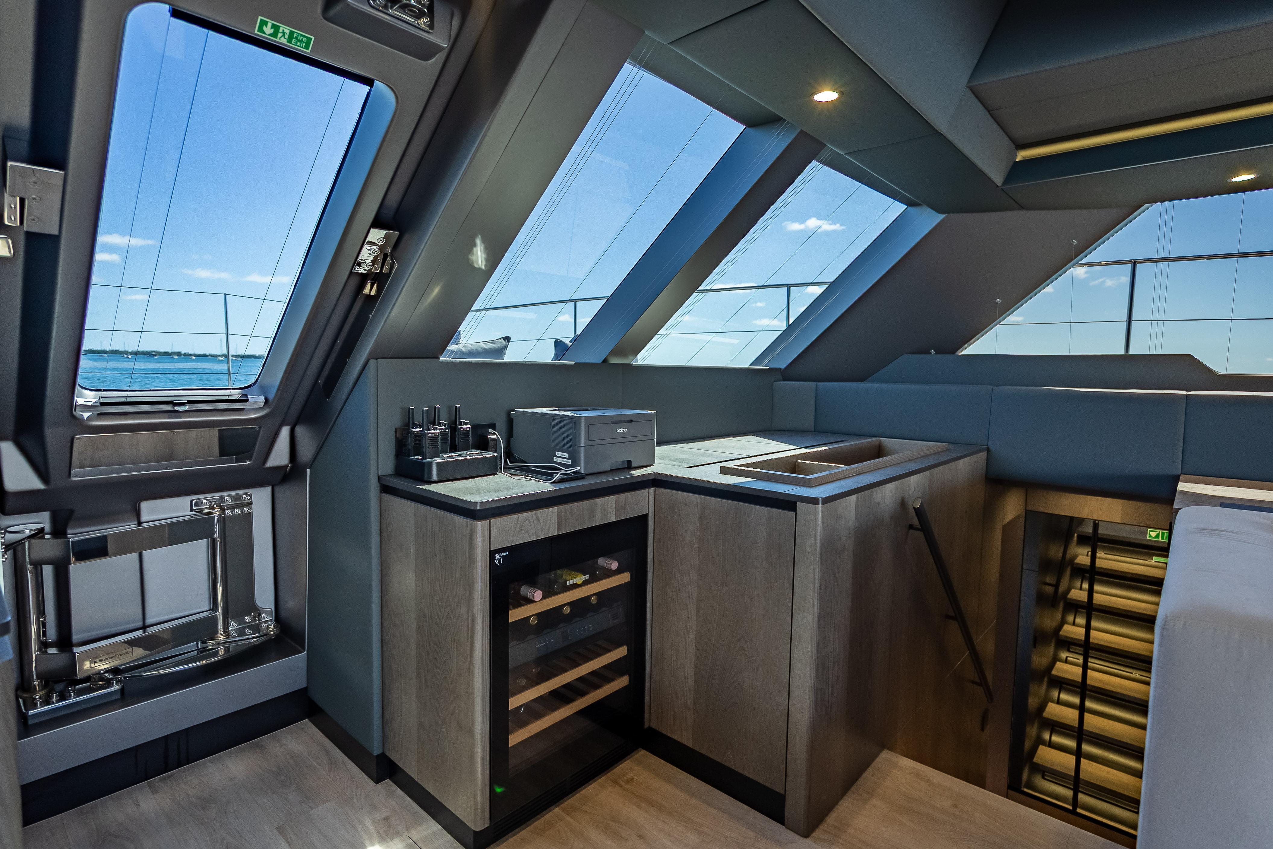 Luxurious interior of 2026 Sunreef 60 Power yacht with modern kitchen and panoramic windows.