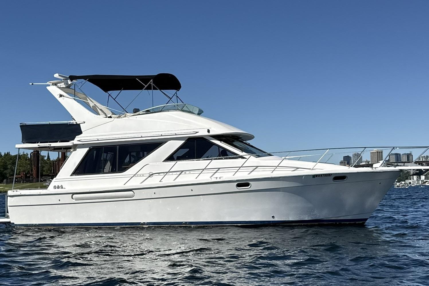 1997 Bayliner 3988 Command Bridge Motoryacht on water, clear sky background.