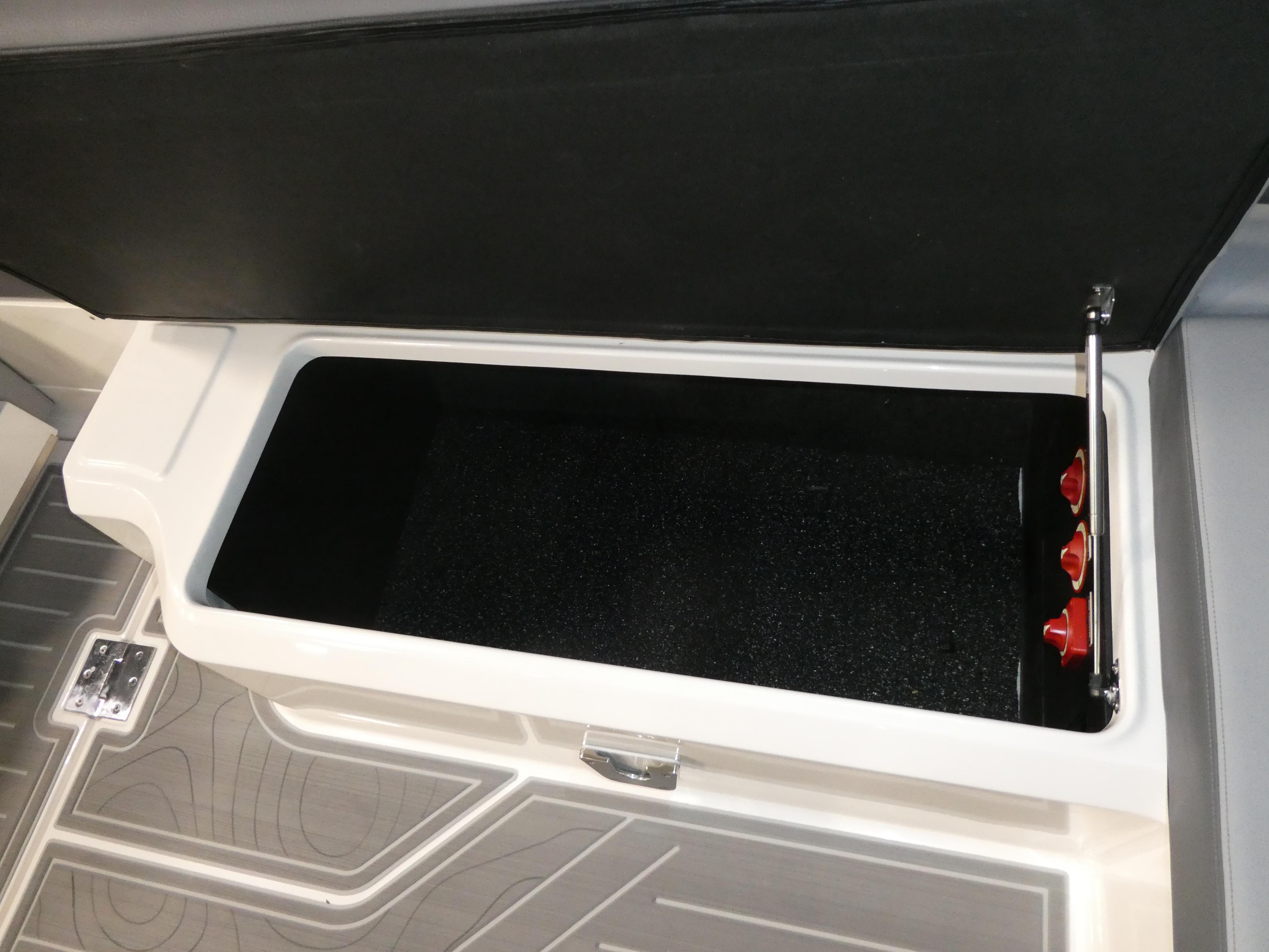 2024 Regal LX9 storage compartment with open lid and interior view.