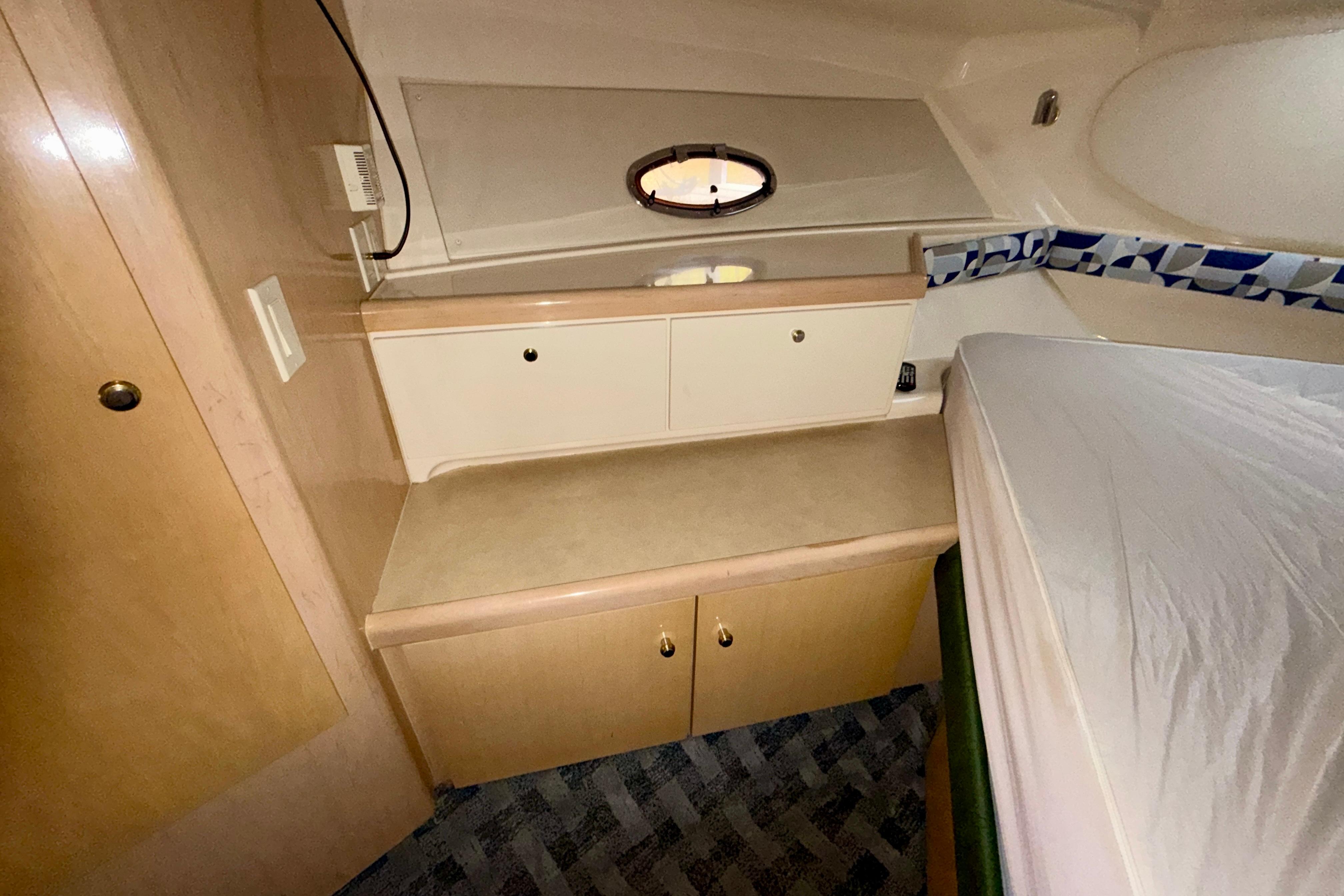 Interior cabin of 2000 Carver 350 Mariner with storage cabinets and bed.