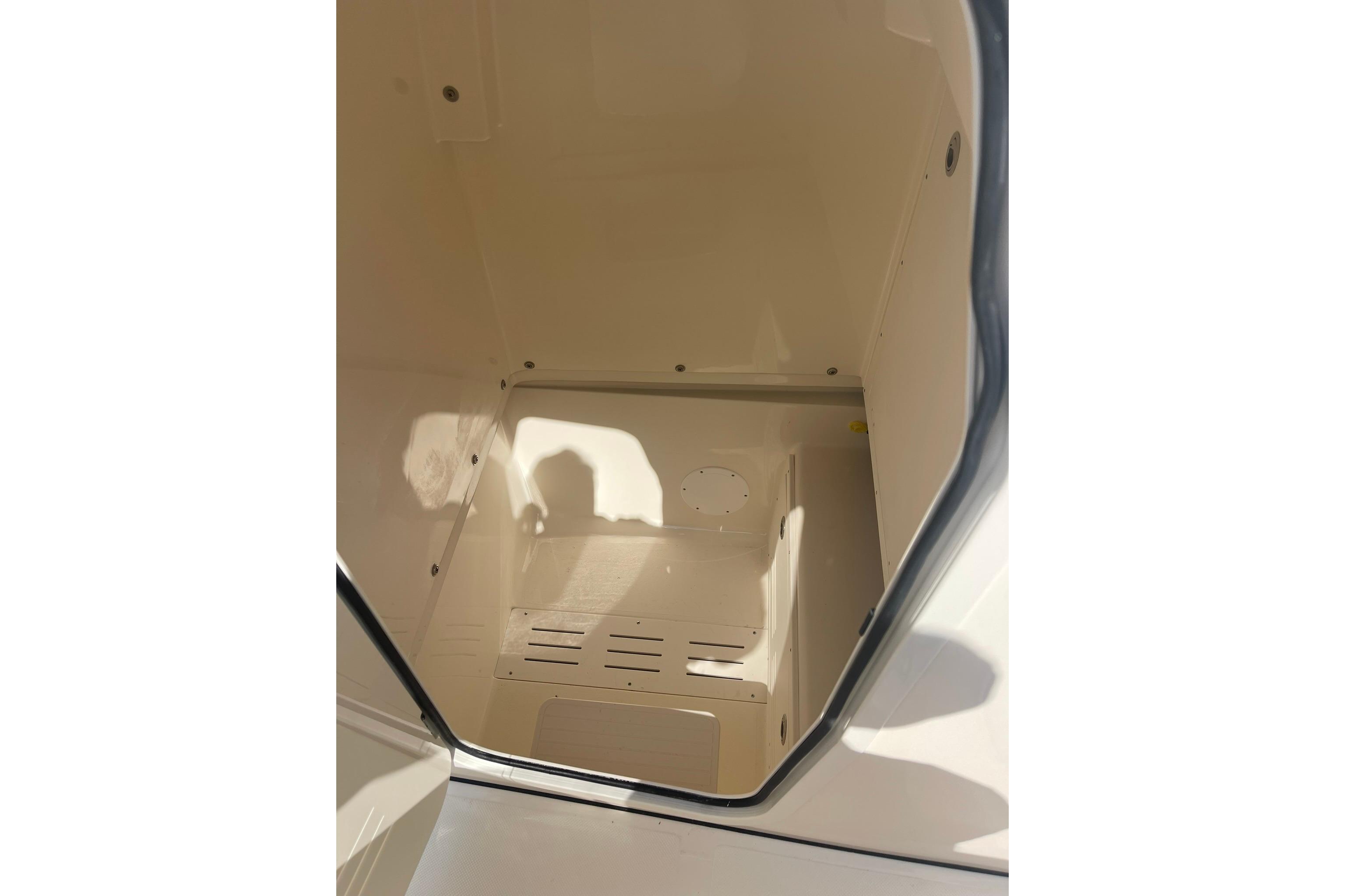Interior view of 2026 Pioneer 250 Pelagic boat compartment, showcasing storage space.