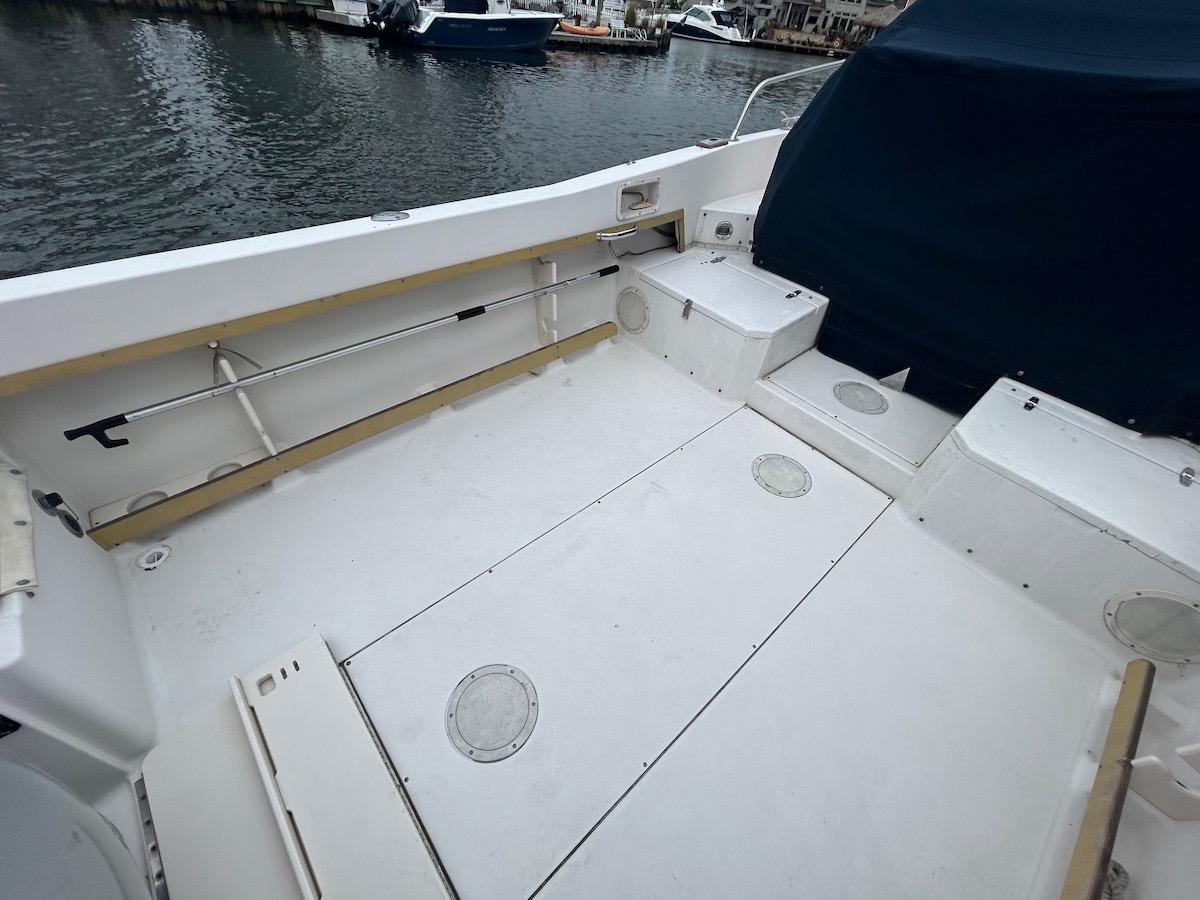 1993 Grady-White 24 Explorer boat deck, spacious and clean, docked by the water.