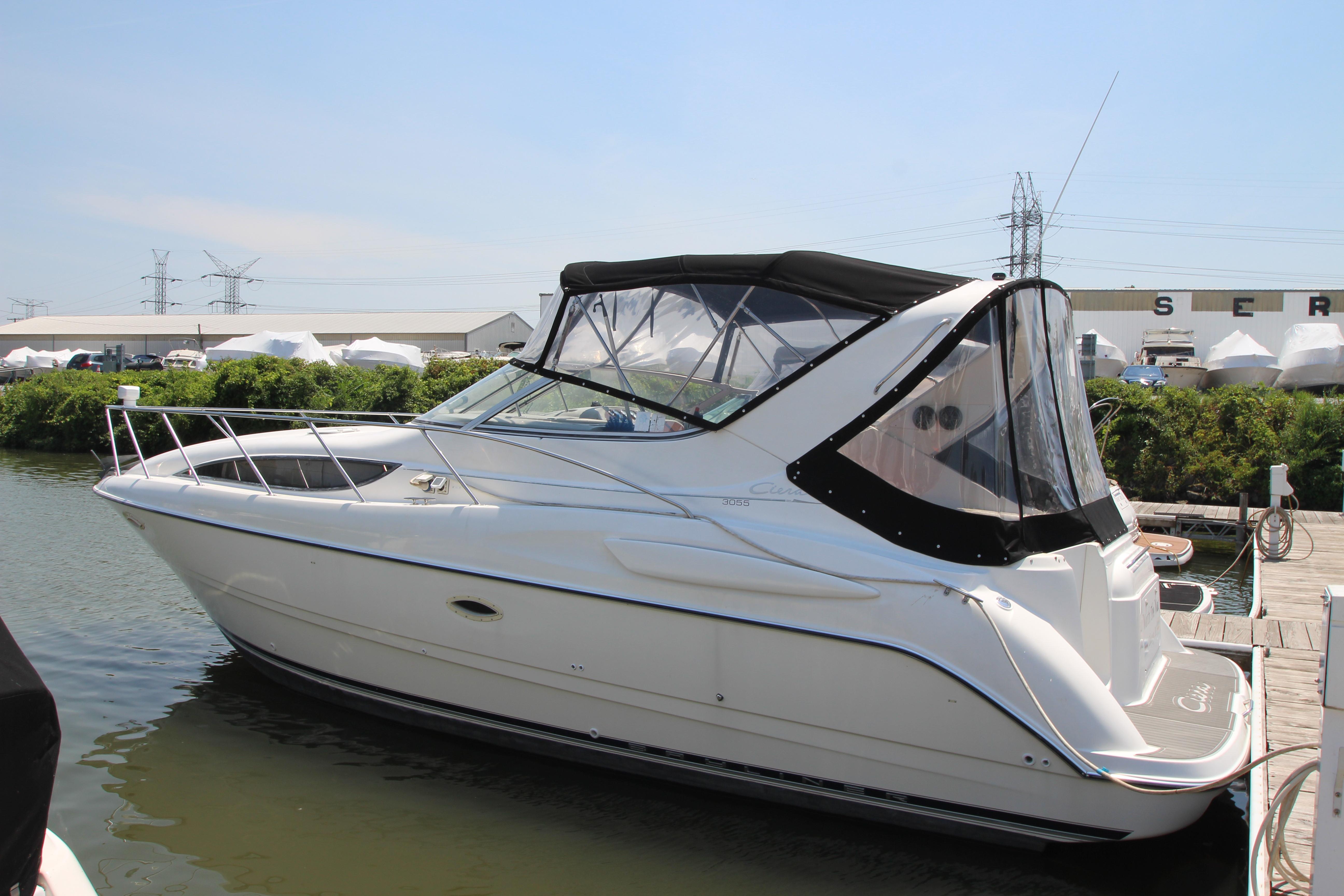 1999 Bayliner 3055 Ciera boat docked at marina, featuring sleek design and covered cockpit.