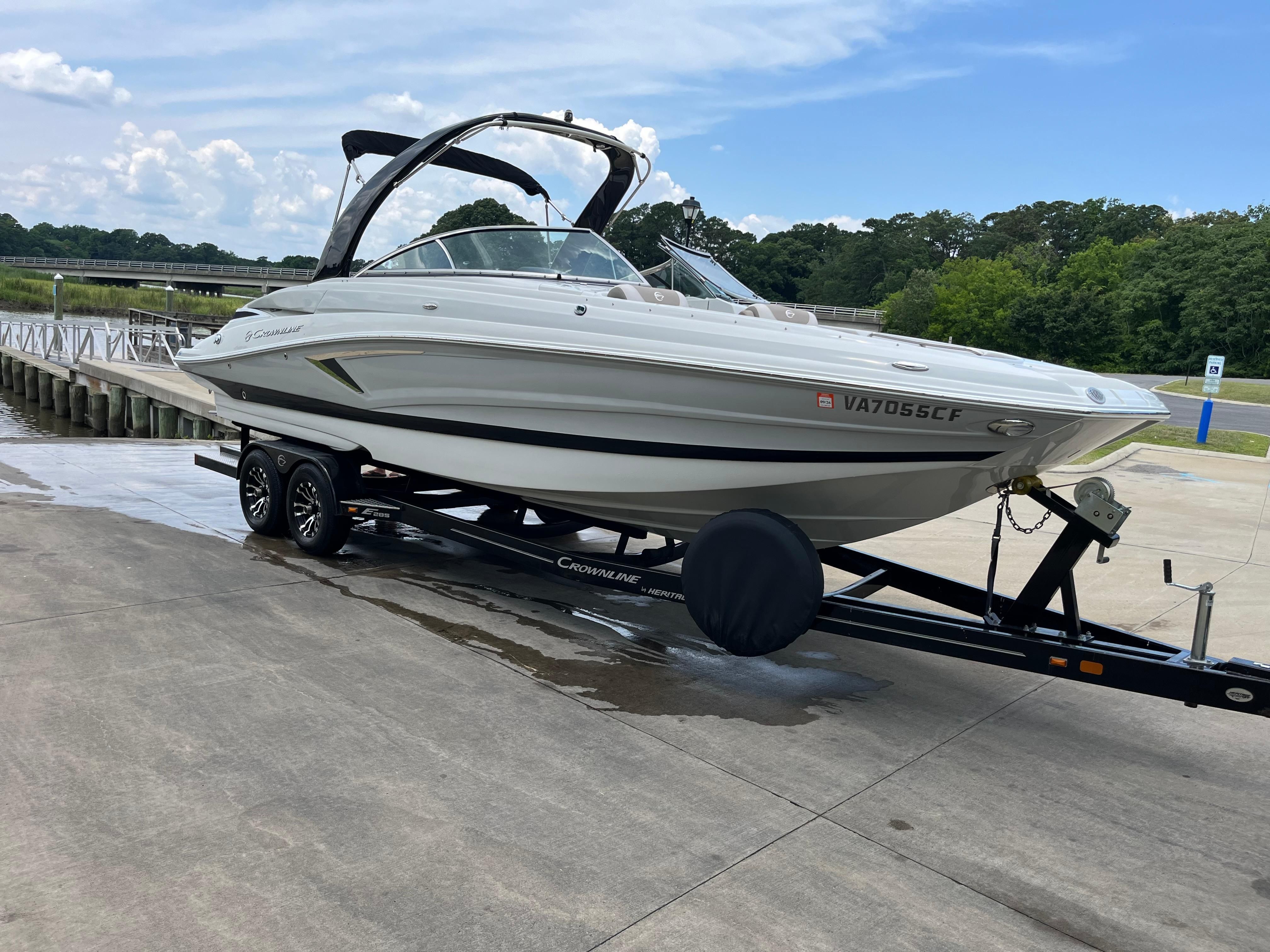 A 2019 Crownline E 285 boat on a trailer at a ramp.