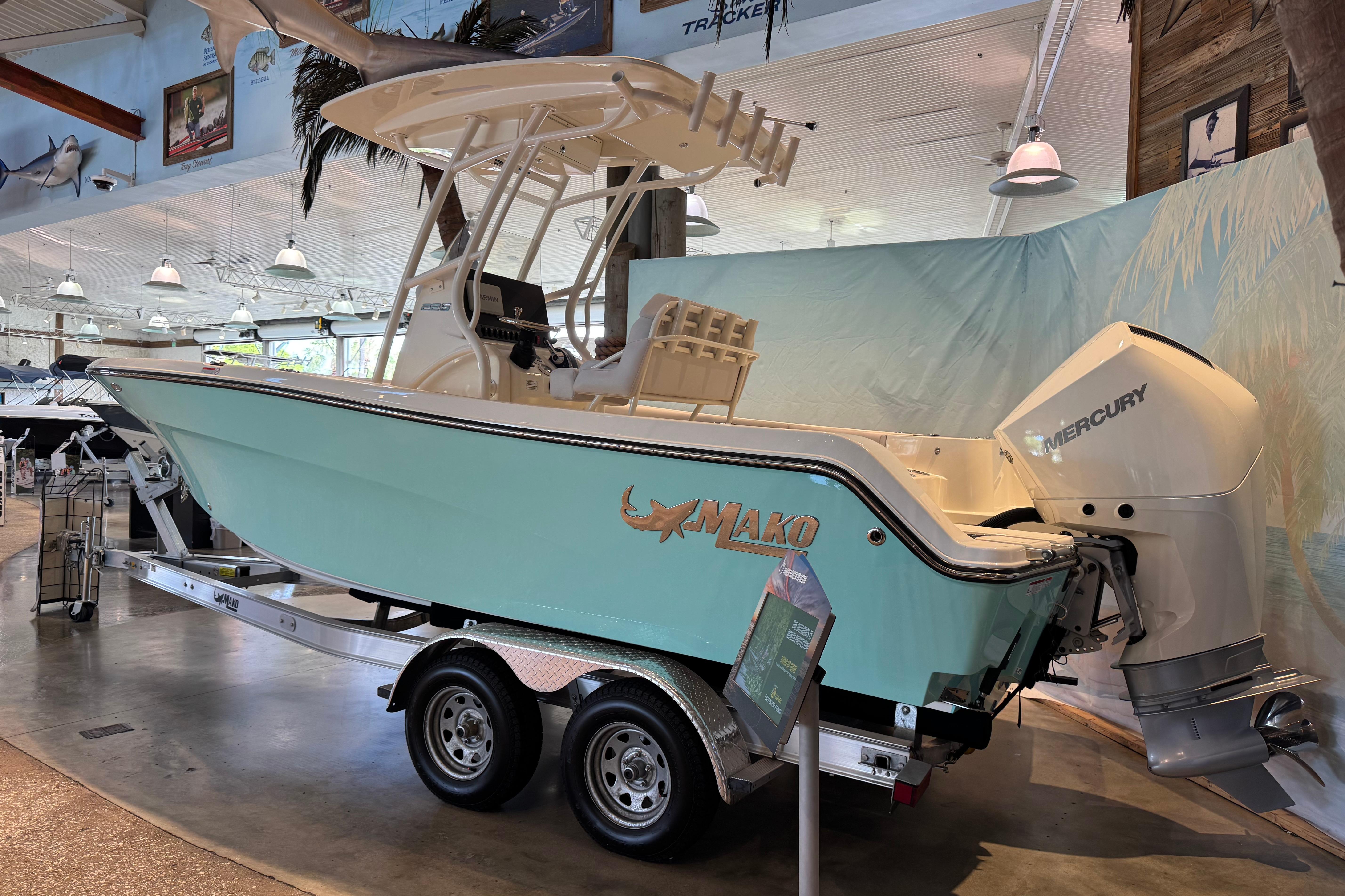 2026 Mako 226 Center Console boat displayed indoors on a trailer.
