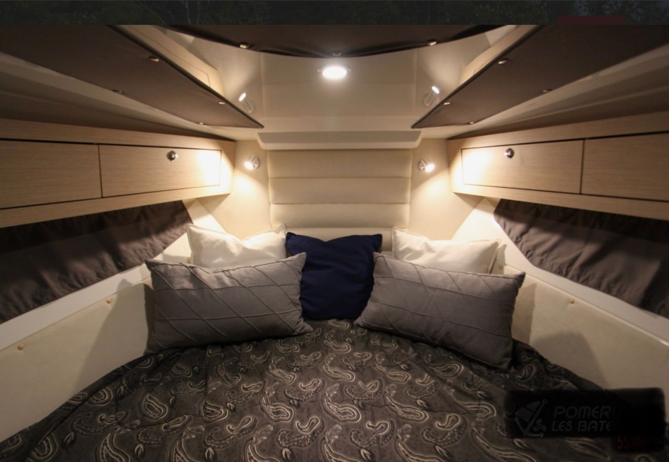 Interior of the Parker Poland 800 Cruiser with a cozy bed and pillows.