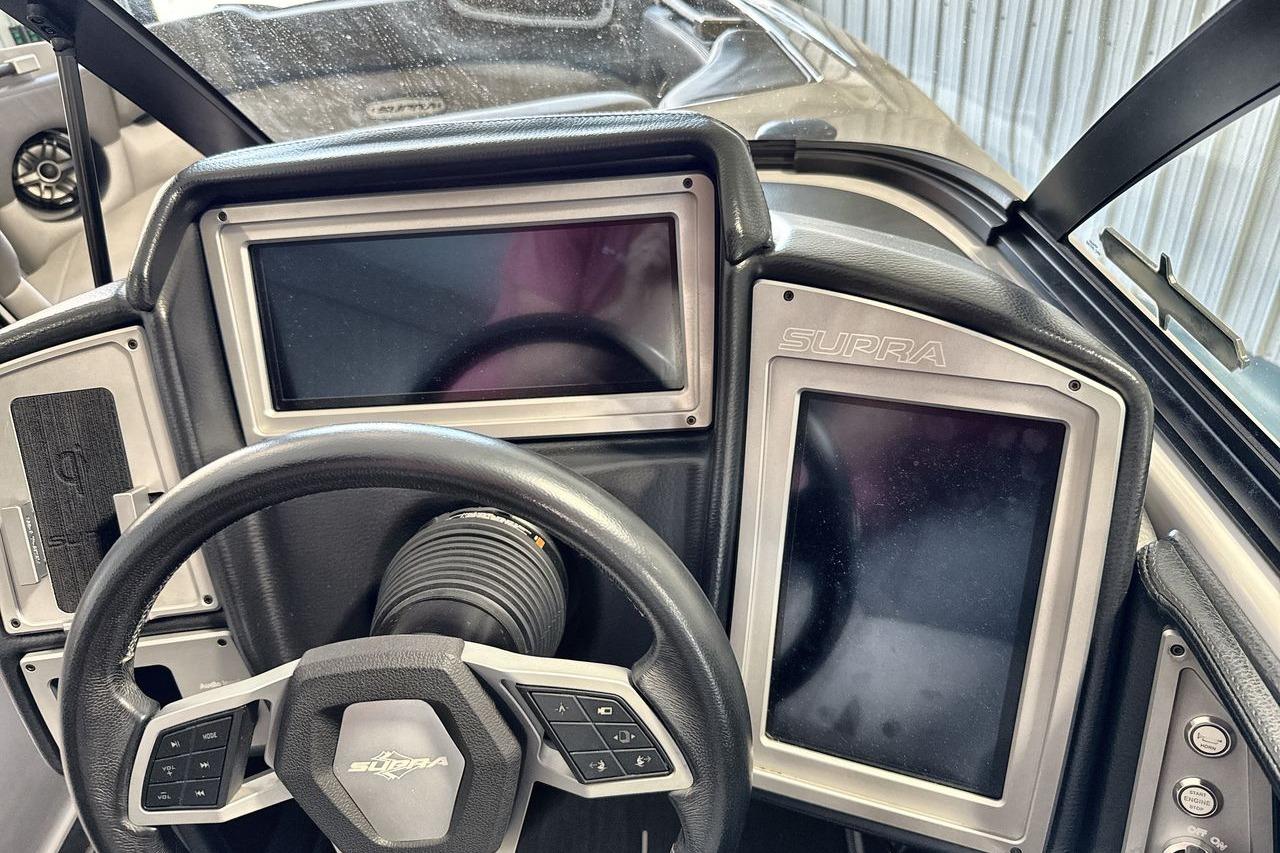 2021 Supra SE 550 dashboard with dual touchscreens and steering wheel controls.
