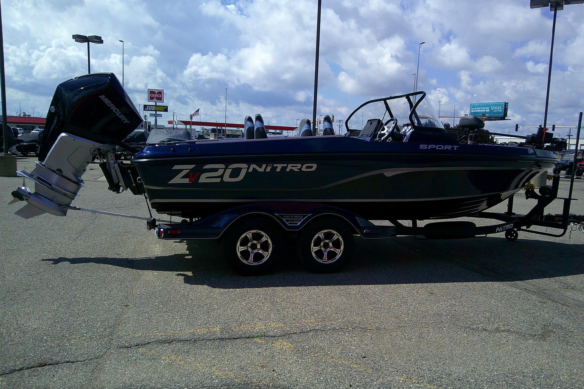 2025 Nitro ZV20 Sport boat on trailer, parked outdoors under cloudy sky.