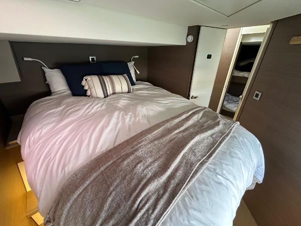 Luxurious bedroom interior in a 2021 Bali 4.8 yacht, featuring a cozy bed and modern design.