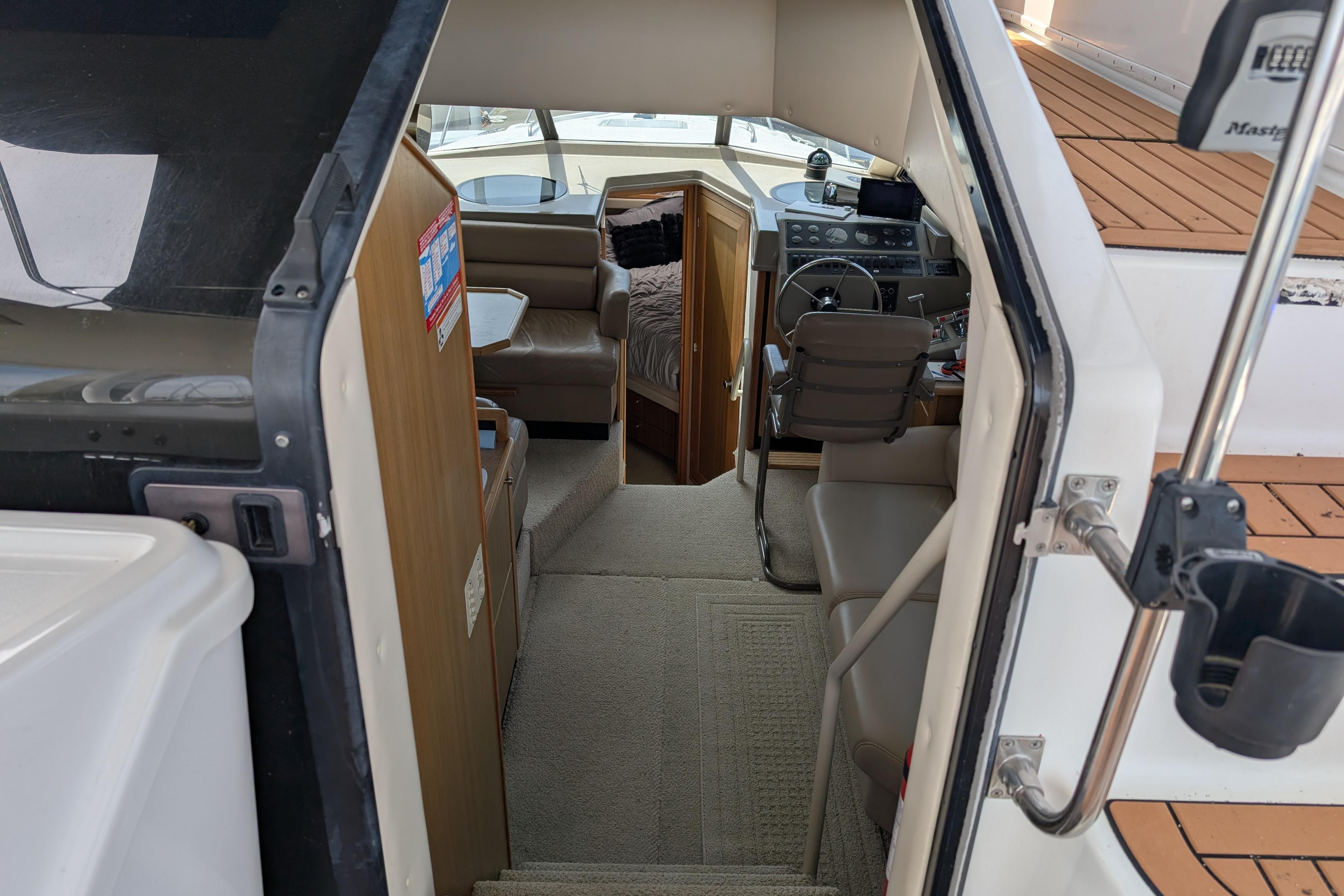 Interior view of a 2000 Bayliner 4088 boat, featuring helm and seating area.
