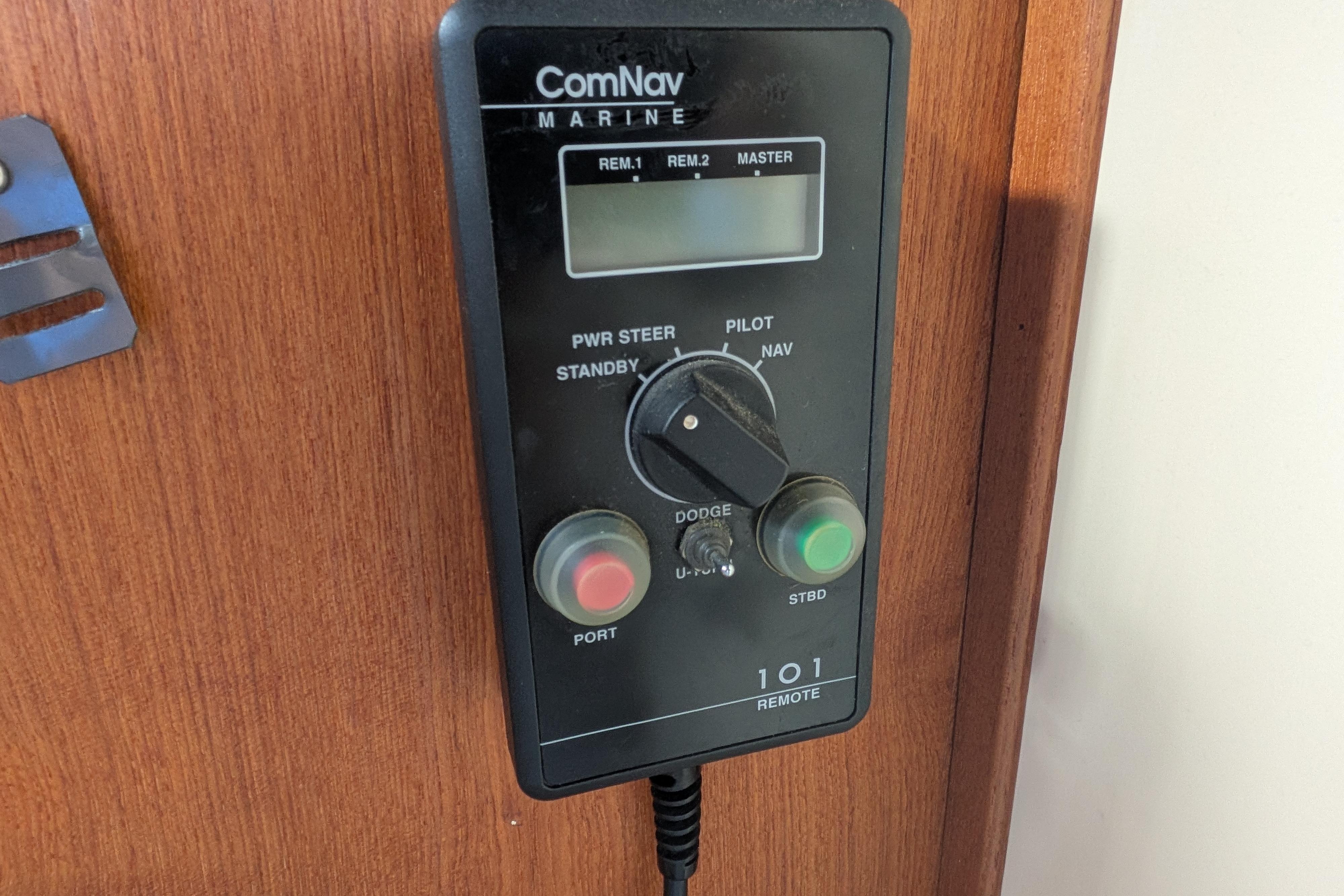 ComNav Marine control panel on 1998 Nordic Tug 32 boat, featuring navigation and steering controls.