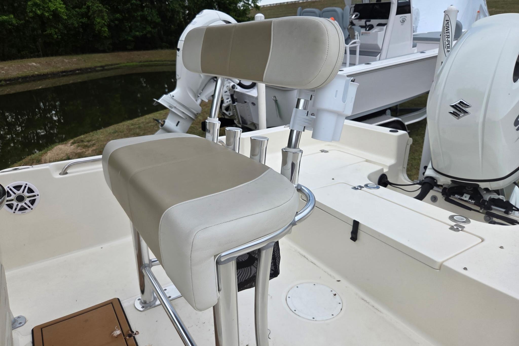 2023 Bulls Bay 2200 boat interior with beige seating and Suzuki outboard motor.