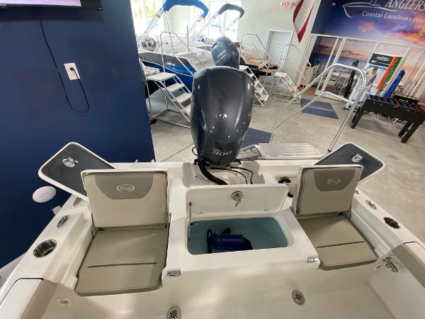 2024 Key West 250 Bay Reef boat interior with motor and seating.