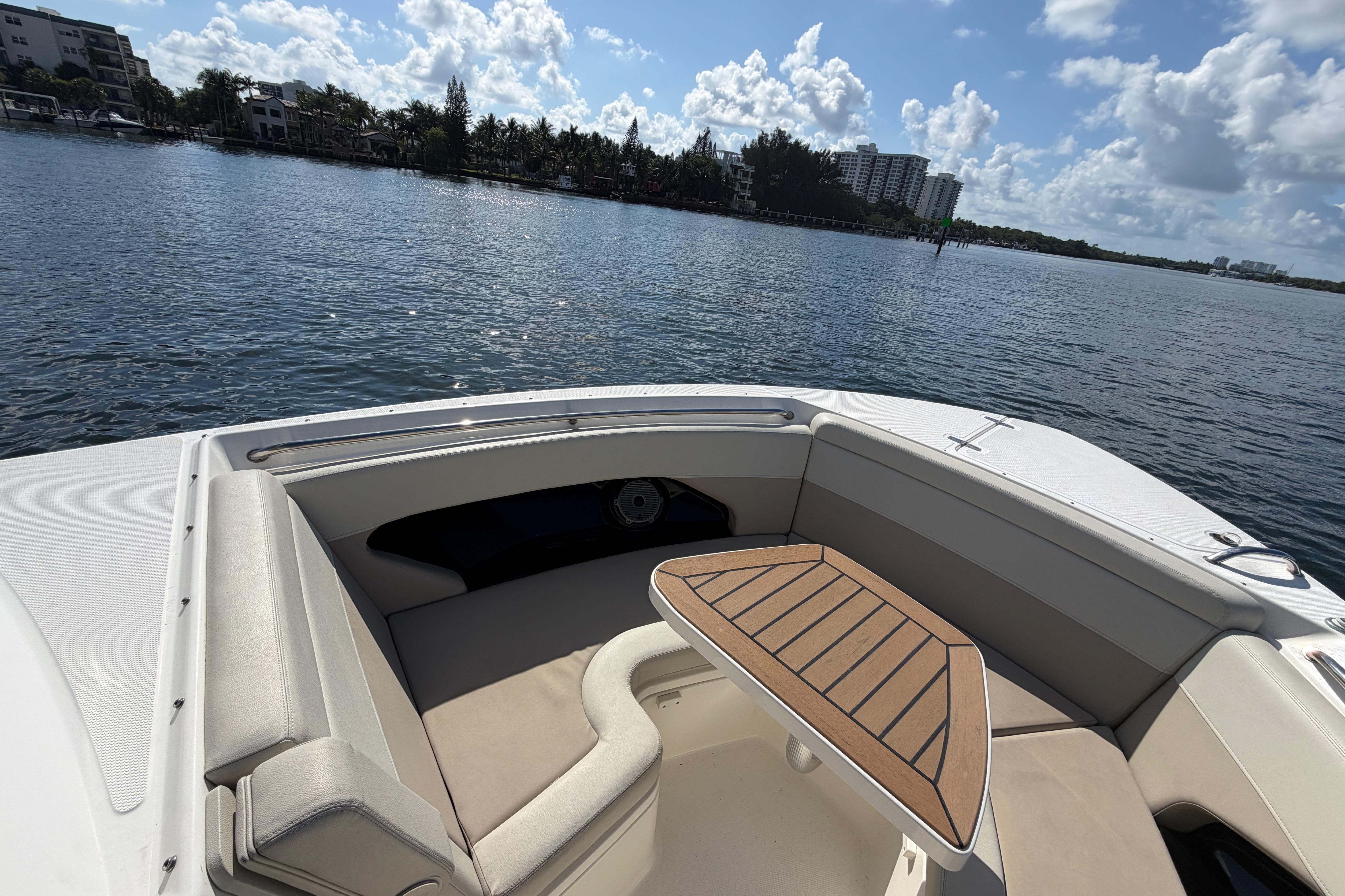 2021 Boston Whaler 280 Vantage boat interior with seating and table on calm water.