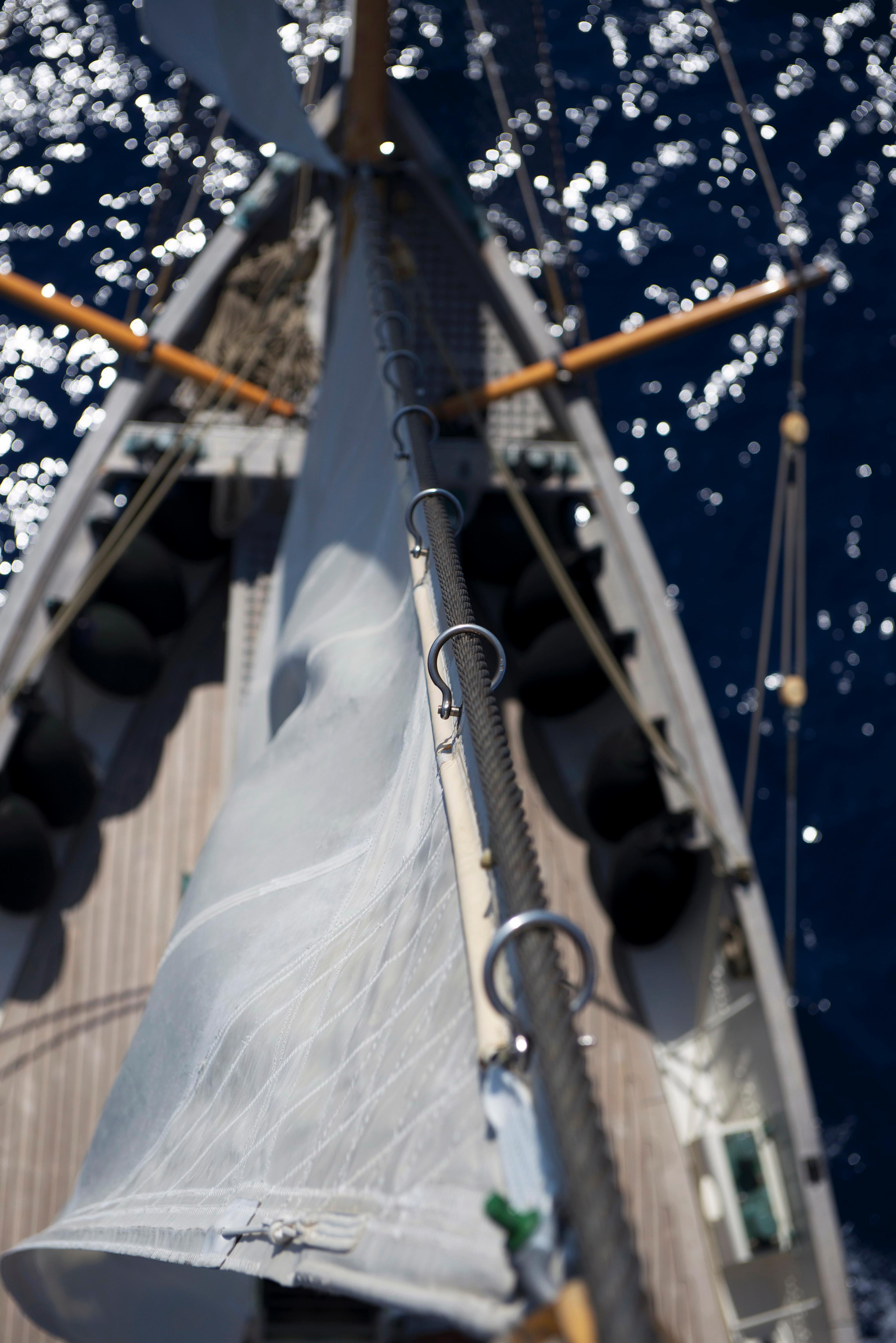 Aerial view of 1920 J.P. Smit Motorsailer Schooner sailing on sparkling blue water.