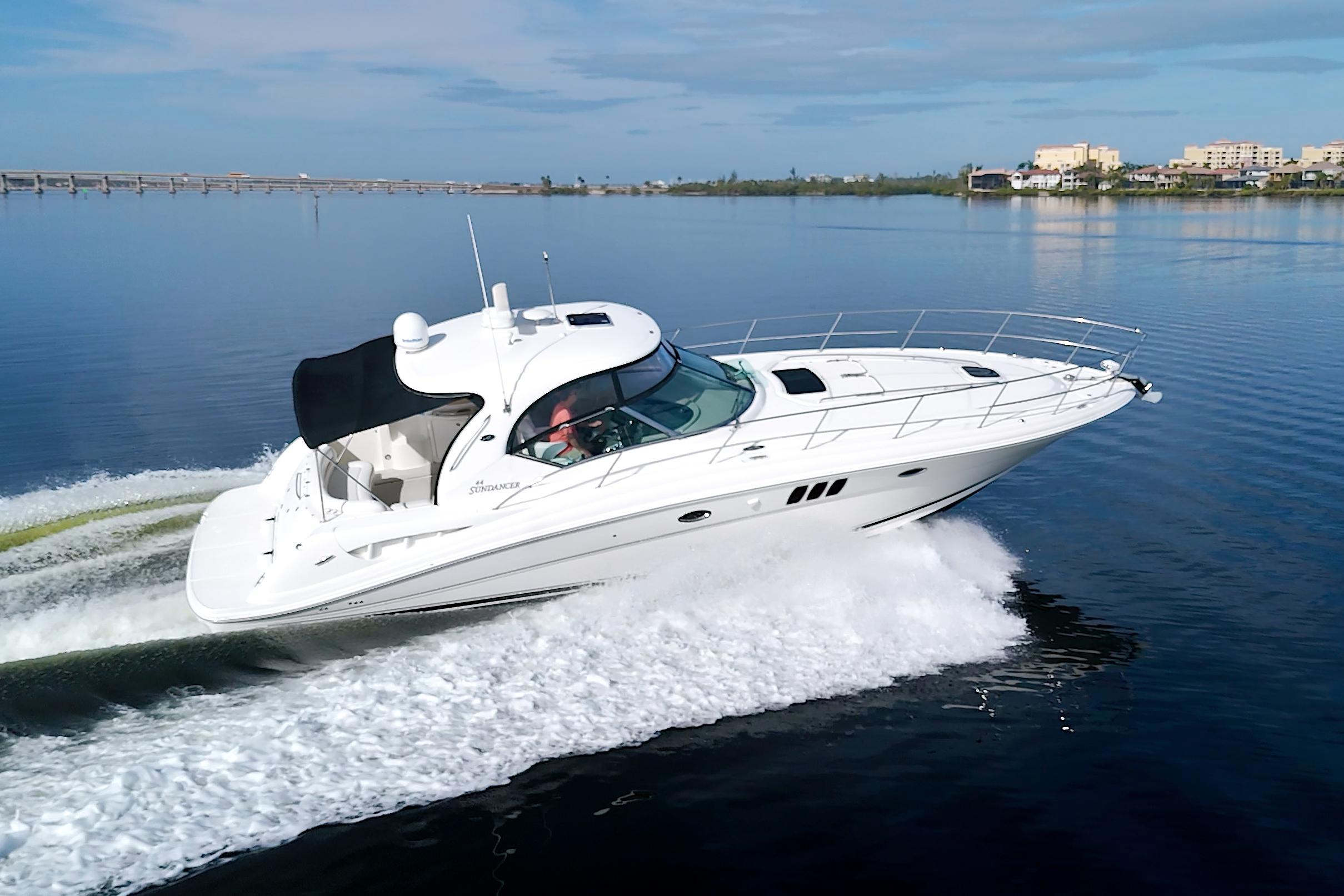 2009 Sea Ray 44 Sundancer cruising on calm waters under a clear sky.