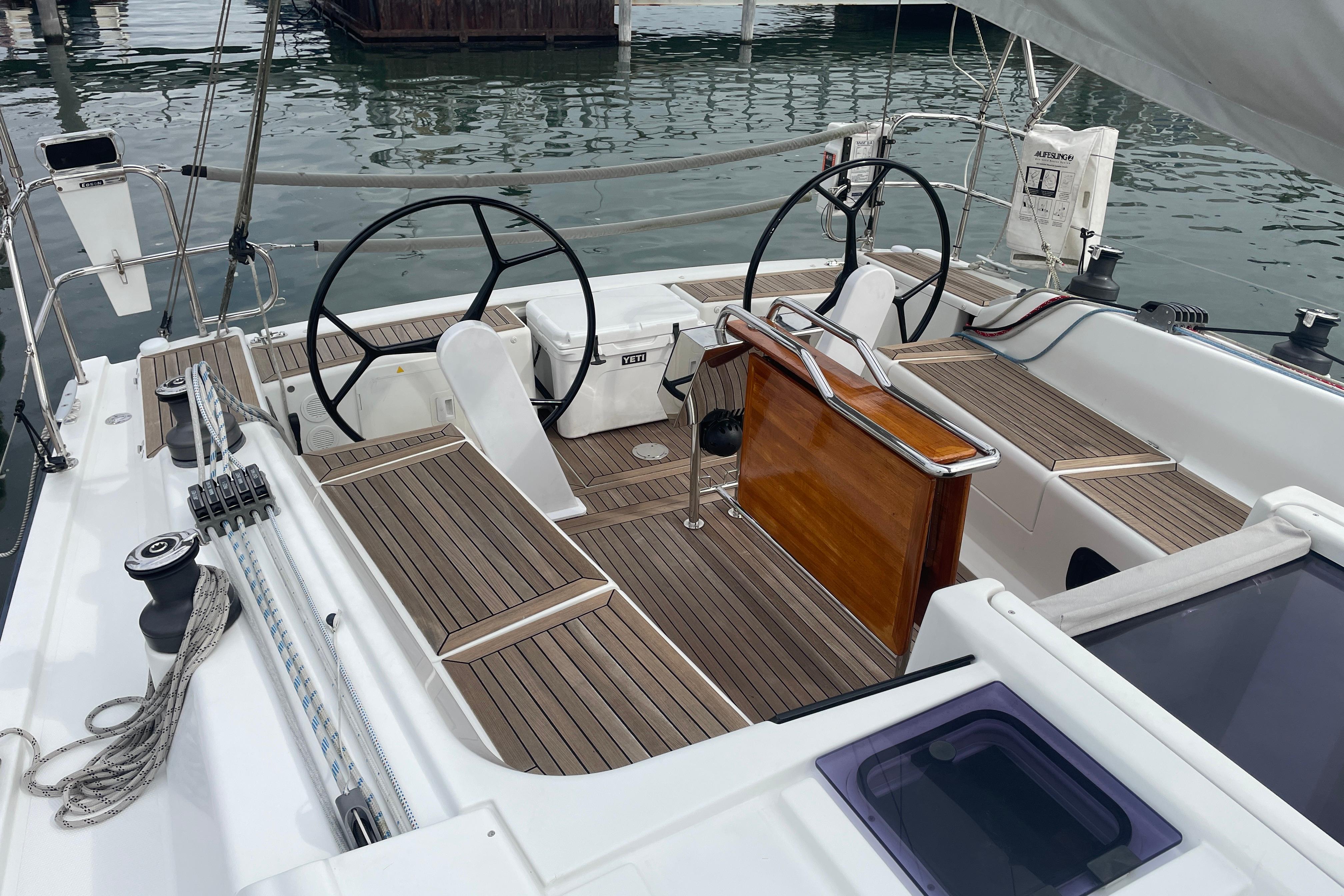 2014 Hanse 415 yacht cockpit with dual steering wheels and teak flooring.