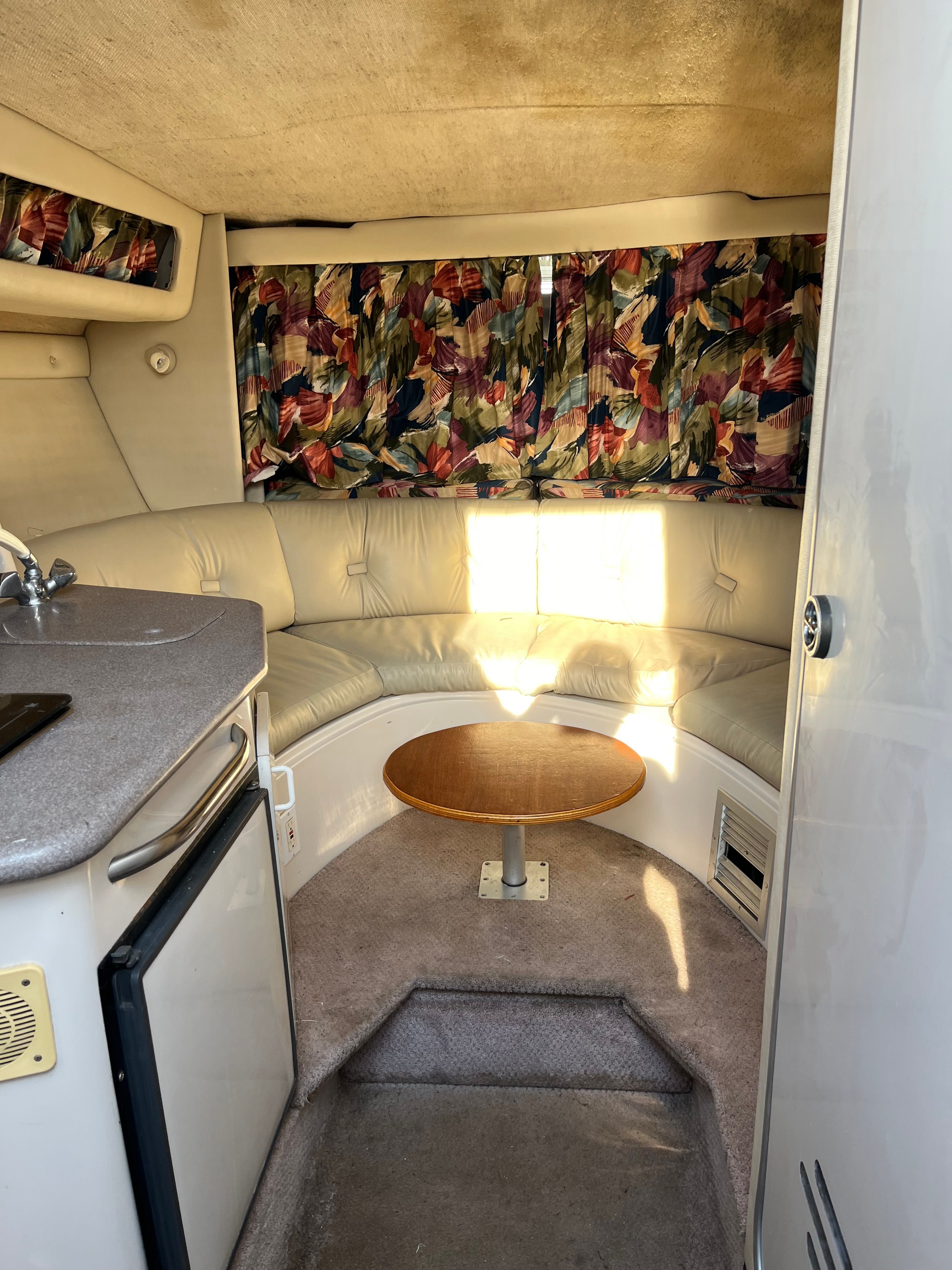 Interior of a Chaparral 290 Signature with seating area and table.