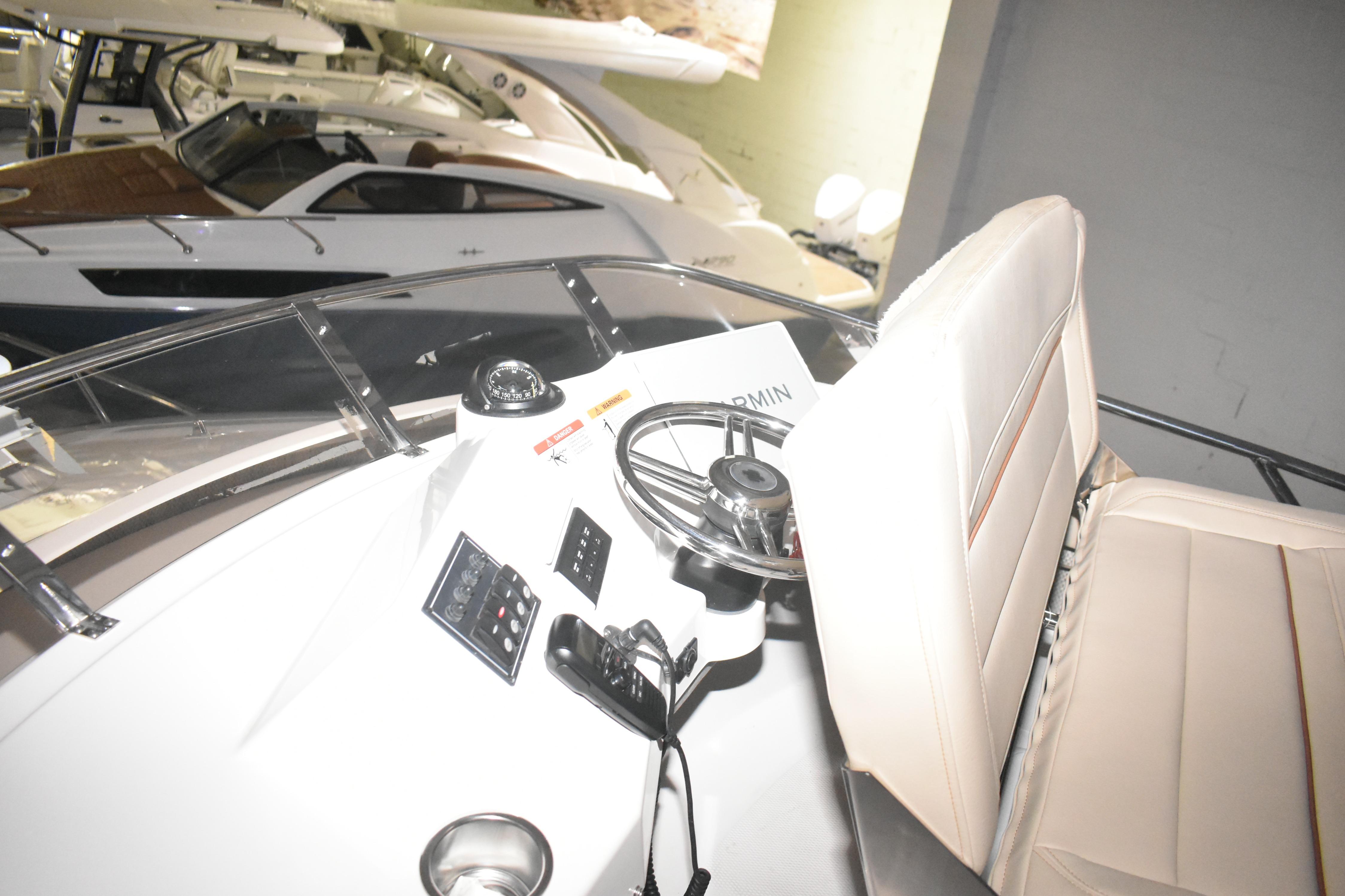 Interior view of 2026 Cutwater C-32 CB boat cockpit with steering wheel and controls.