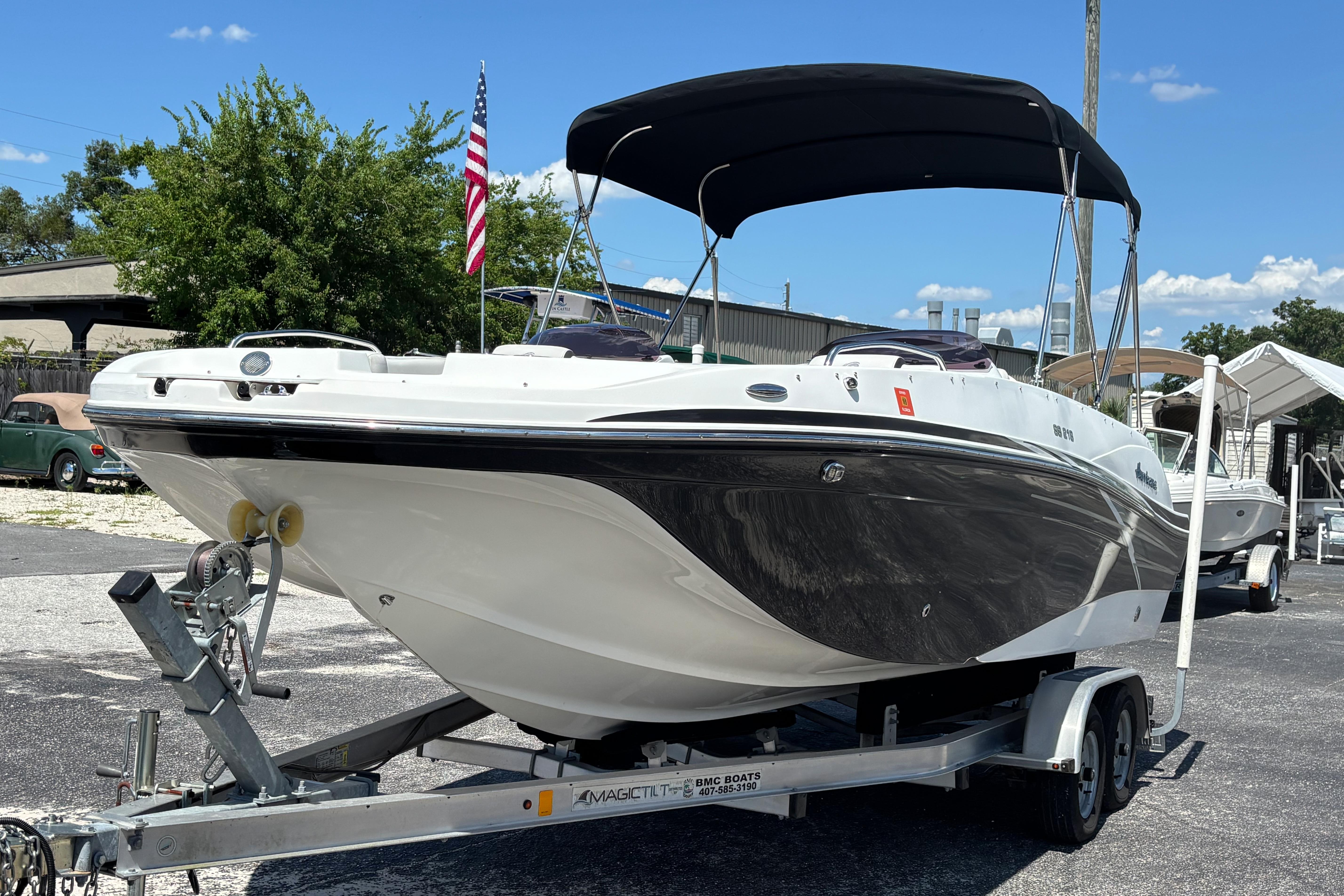 2019 Hurricane Sundeck Sport 218 OB boat on trailer, parked outdoors.