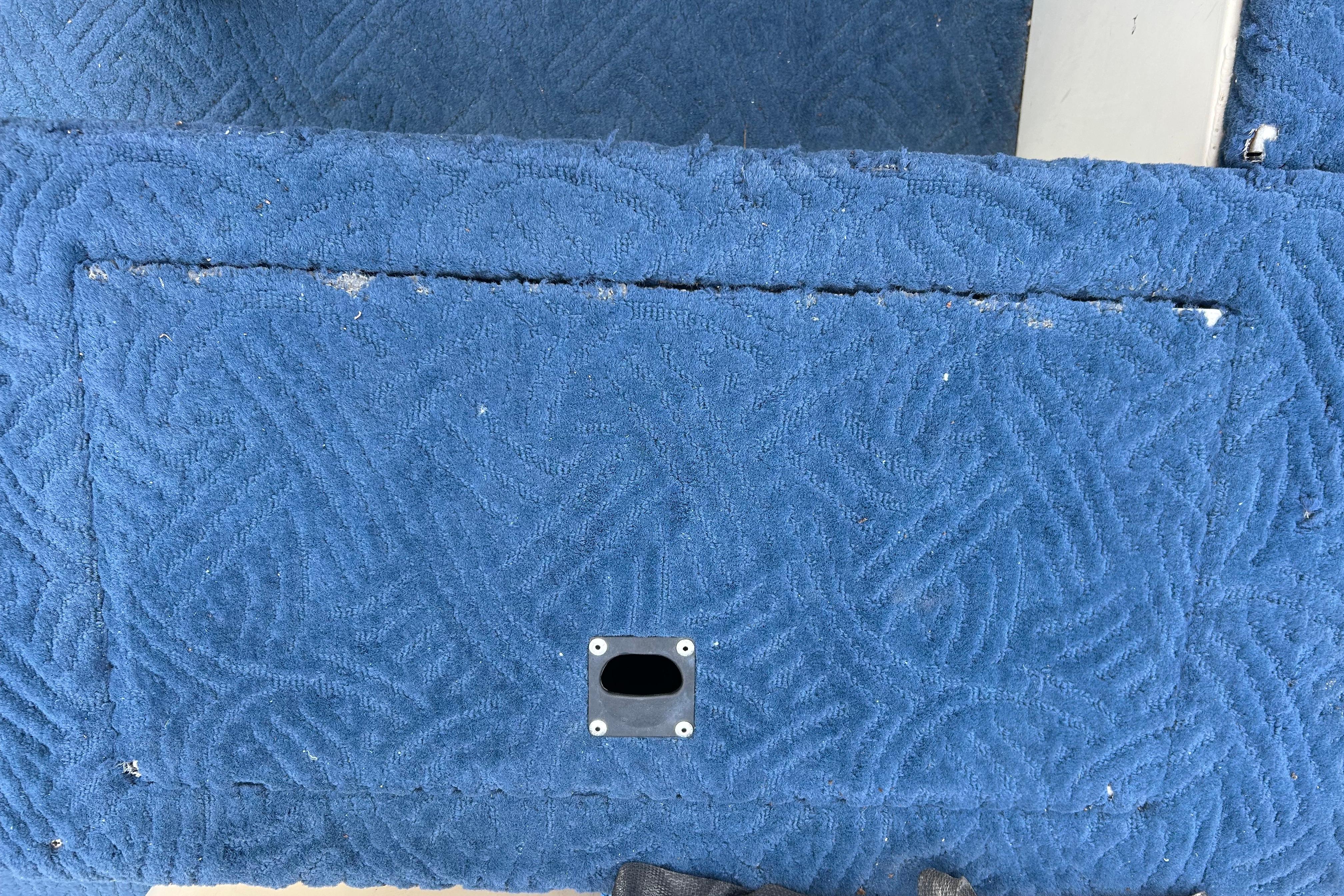 Blue textured upholstery on a 2002 Lowe Trinidad 200 boat interior.