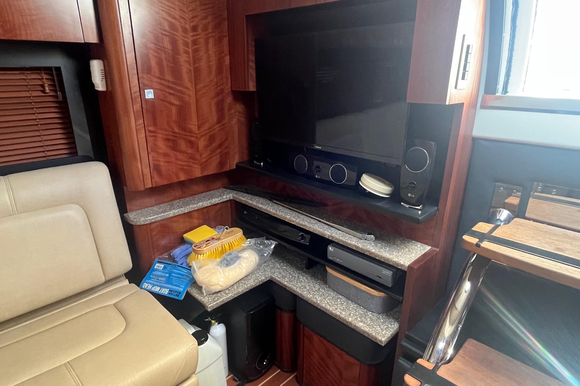 Interior of 2010 Monterey 400 Sport Yacht with entertainment system and storage shelves.