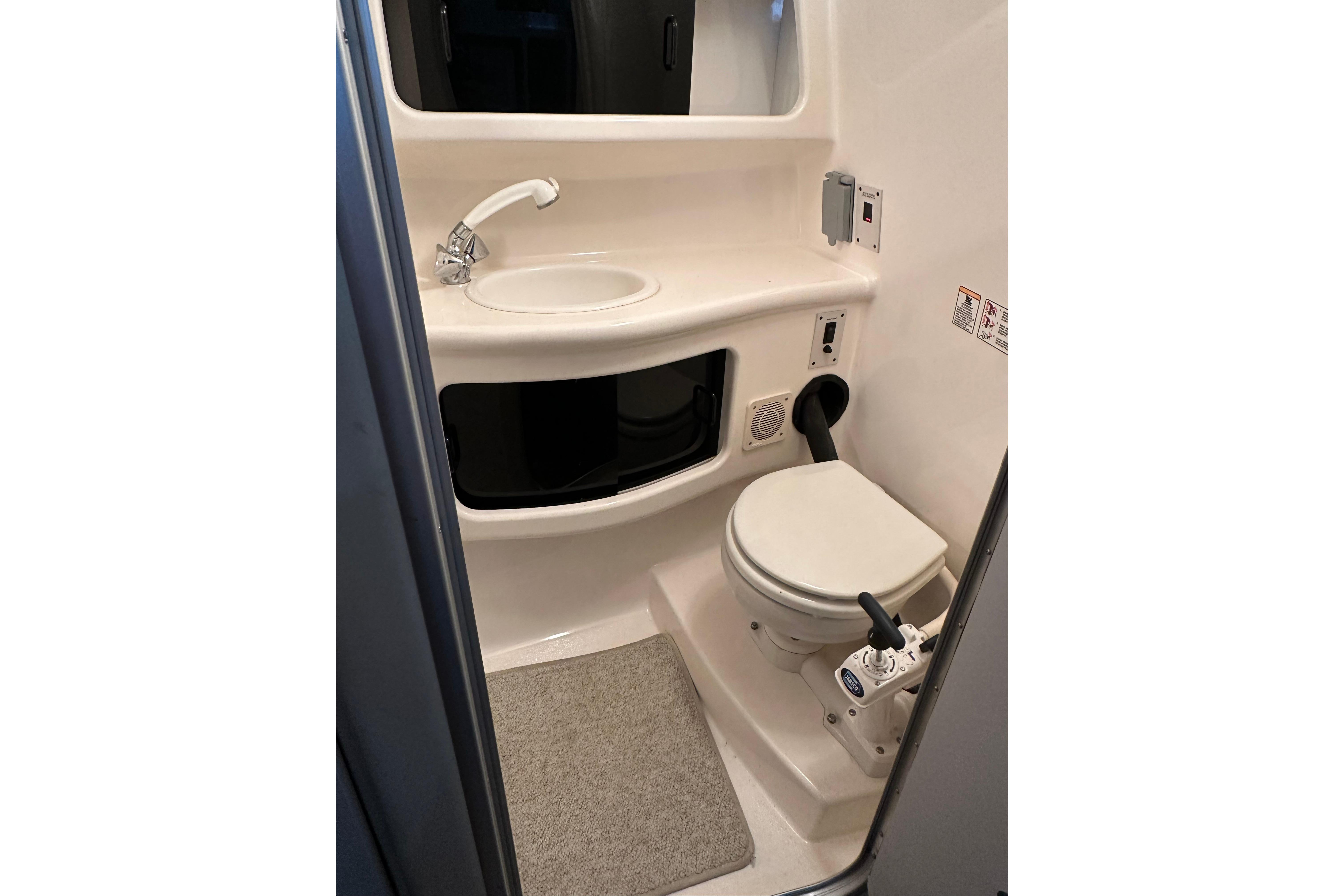 1998 Chaparral Signature 2600 boat bathroom with sink and toilet.