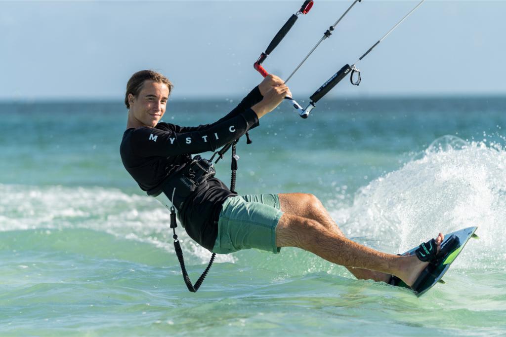 Man kiteboarding on the ocean, enjoying water sports adventure.