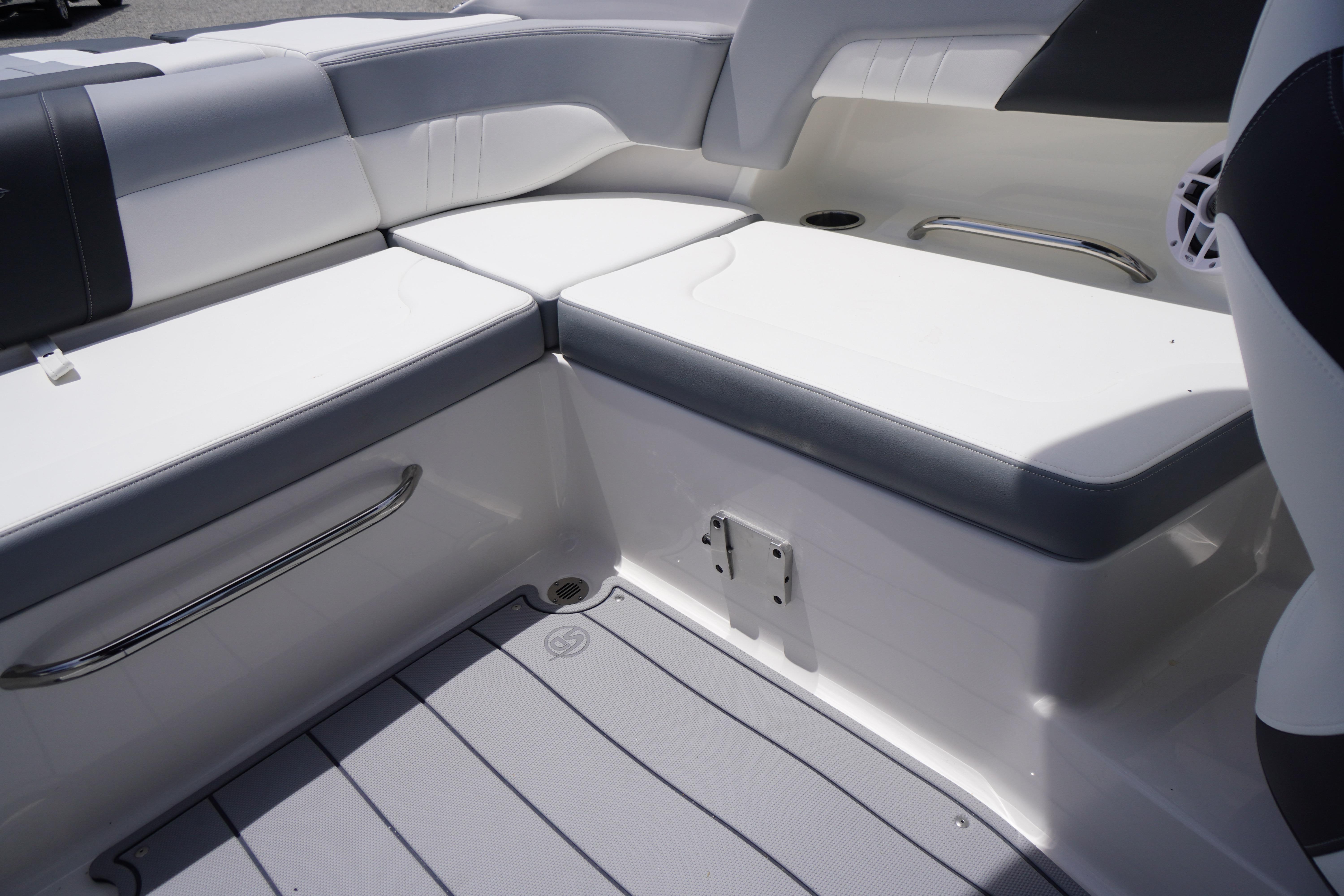 Interior seating of 2026 Chaparral 23 SSi OB boat, featuring sleek white and gray upholstery.