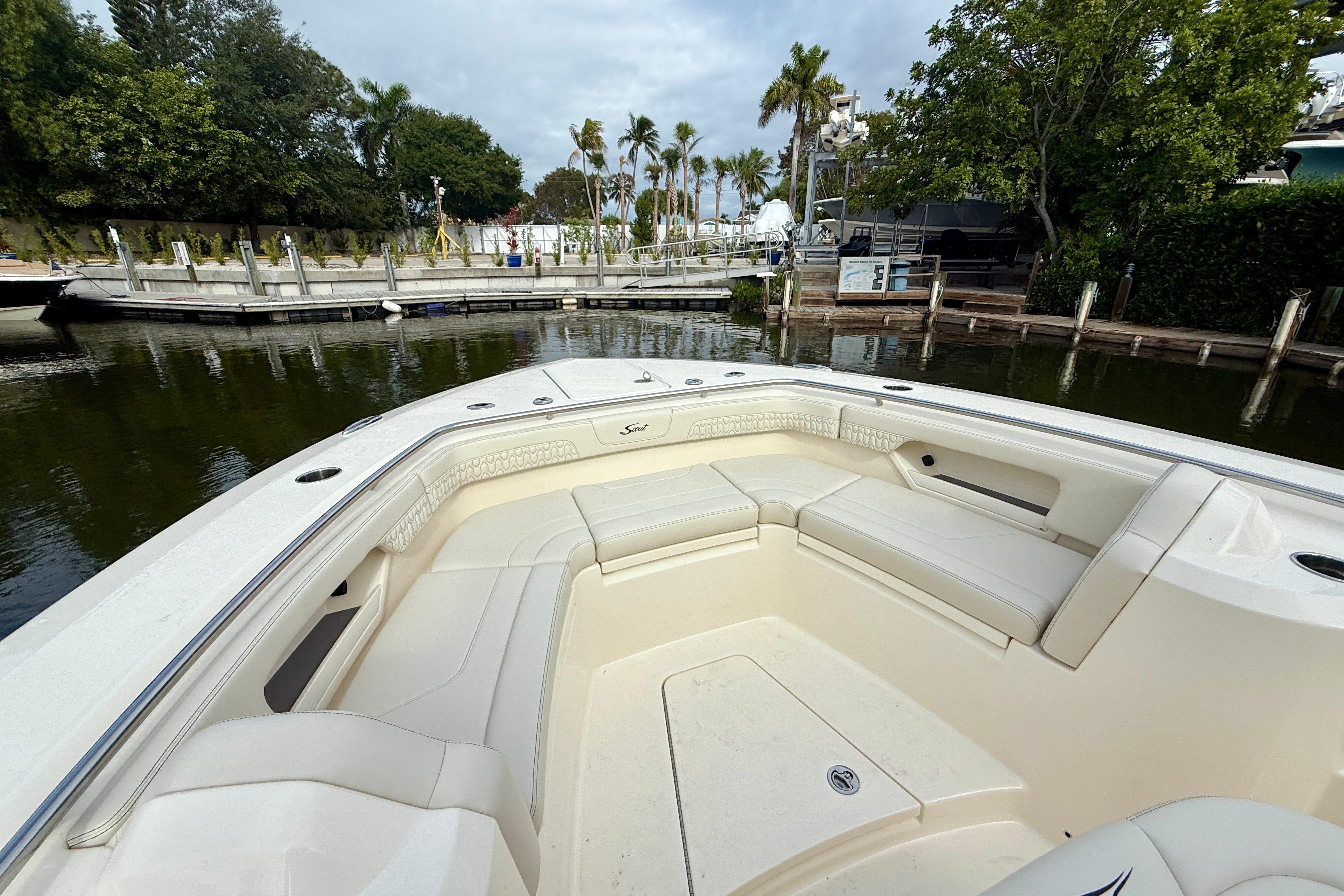 2026 Scout 288 LXF boat with spacious seating at a marina.