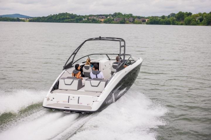 2026 Yamaha Boats AR250 cruising on a lake with passengers enjoying the ride.