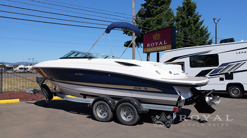 2014 Sea Ray SLX 230 on a trailer, parked in a lot.