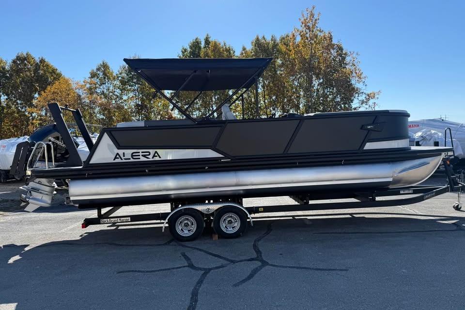 2026 Alera M 25Q pontoon boat on trailer, parked outdoors.