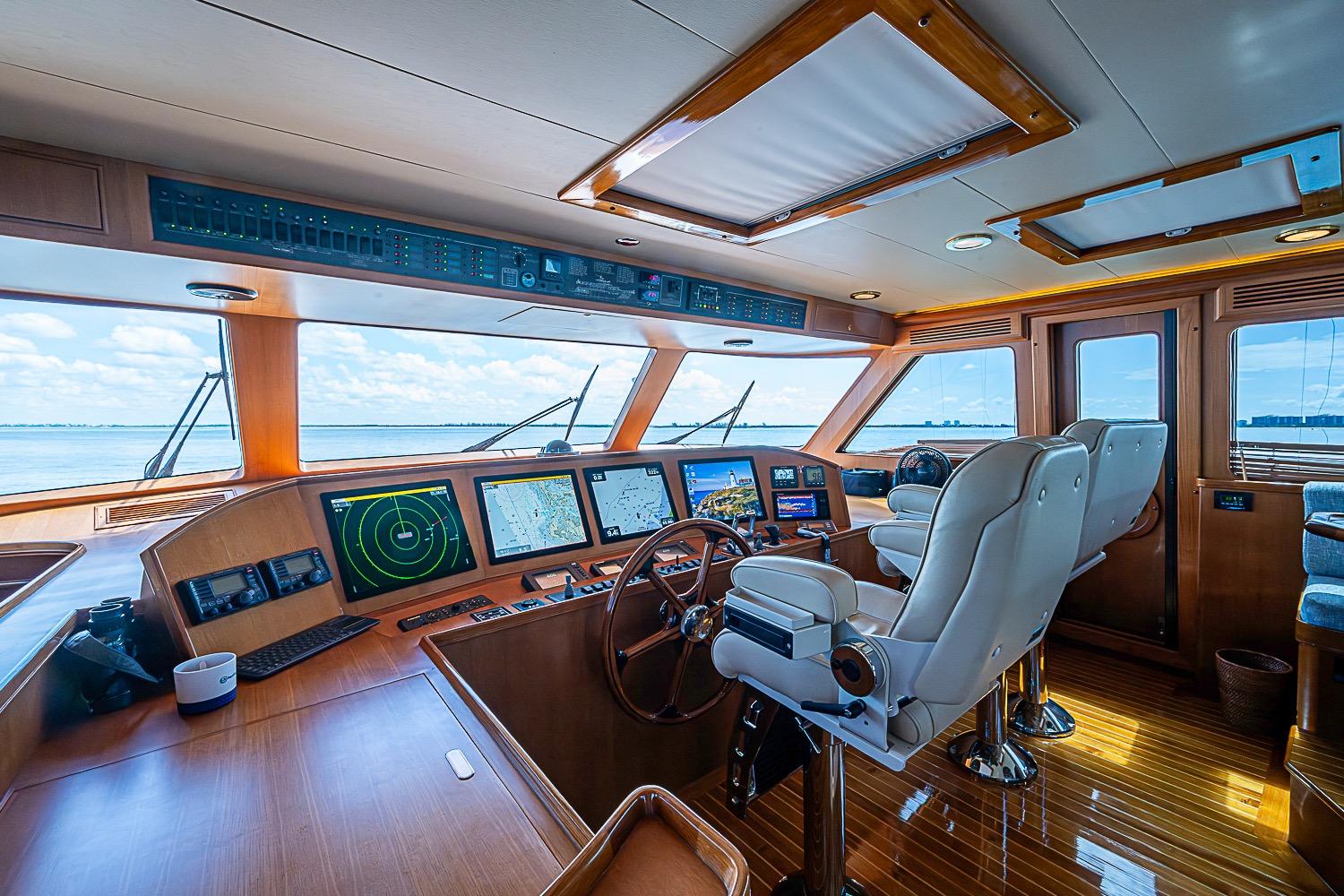 Luxurious 2014 Marlow 80 Explorer yacht cockpit with advanced navigation systems and plush seating.