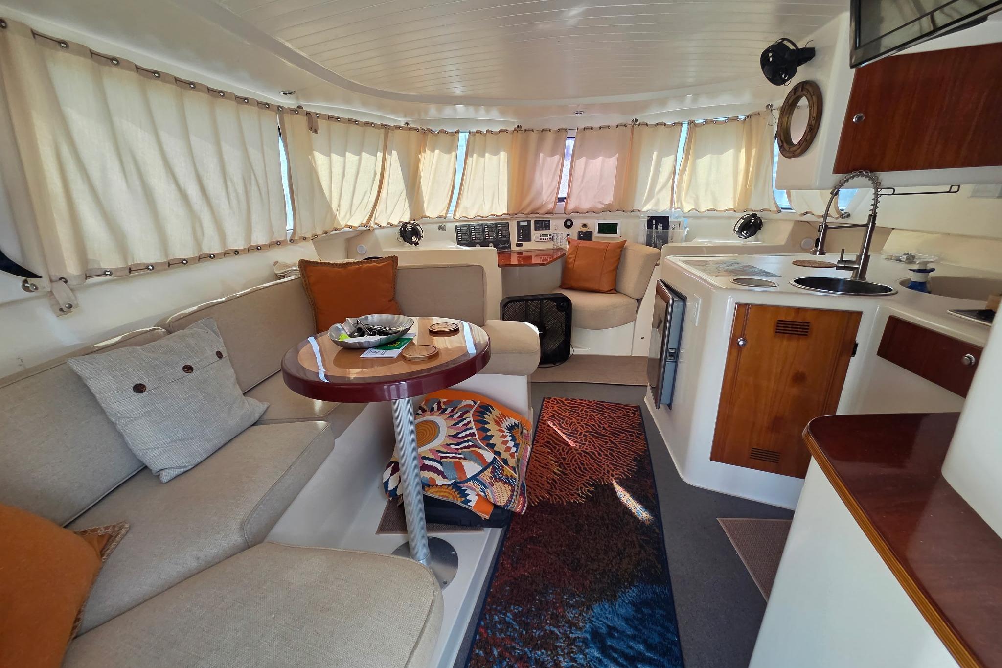 Interior of 2000 Fountaine Pajot Maryland 37 yacht with cozy seating and kitchen area.