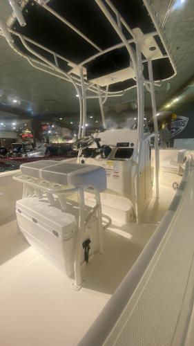 2024 Mako 214 CC center console boat interior with T-top and seating.