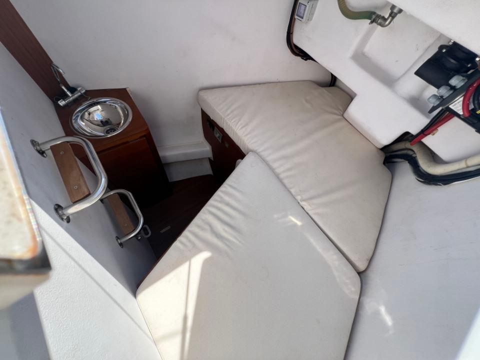 Interior of 2023 Solaris 50 yacht with compact sink and cushioned seating area.
