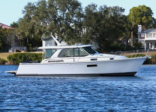 2025 Sabre 43 Salon Express yacht on a serene lake.